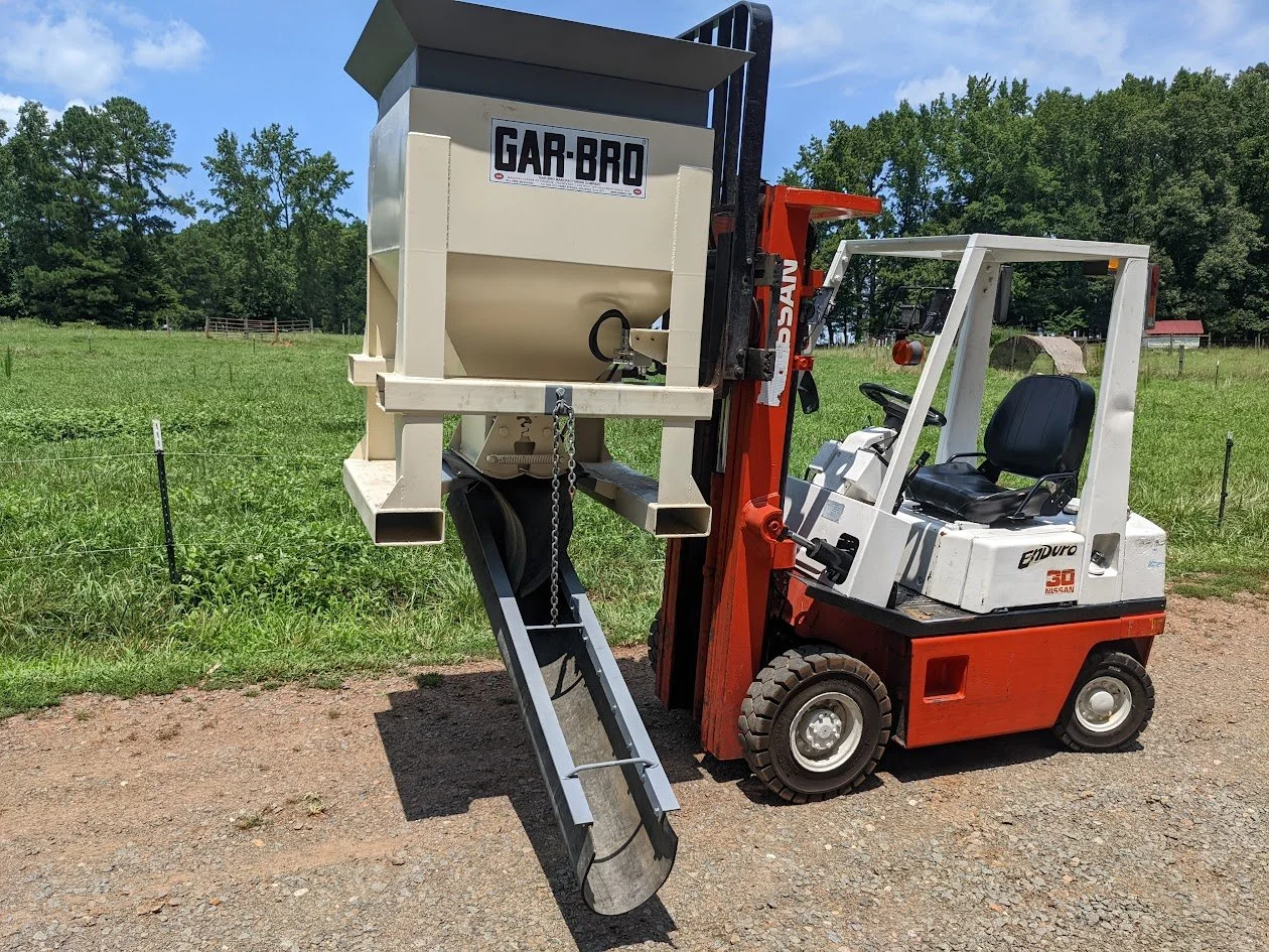 Adapted a side deposit chute for a concrete hopper.