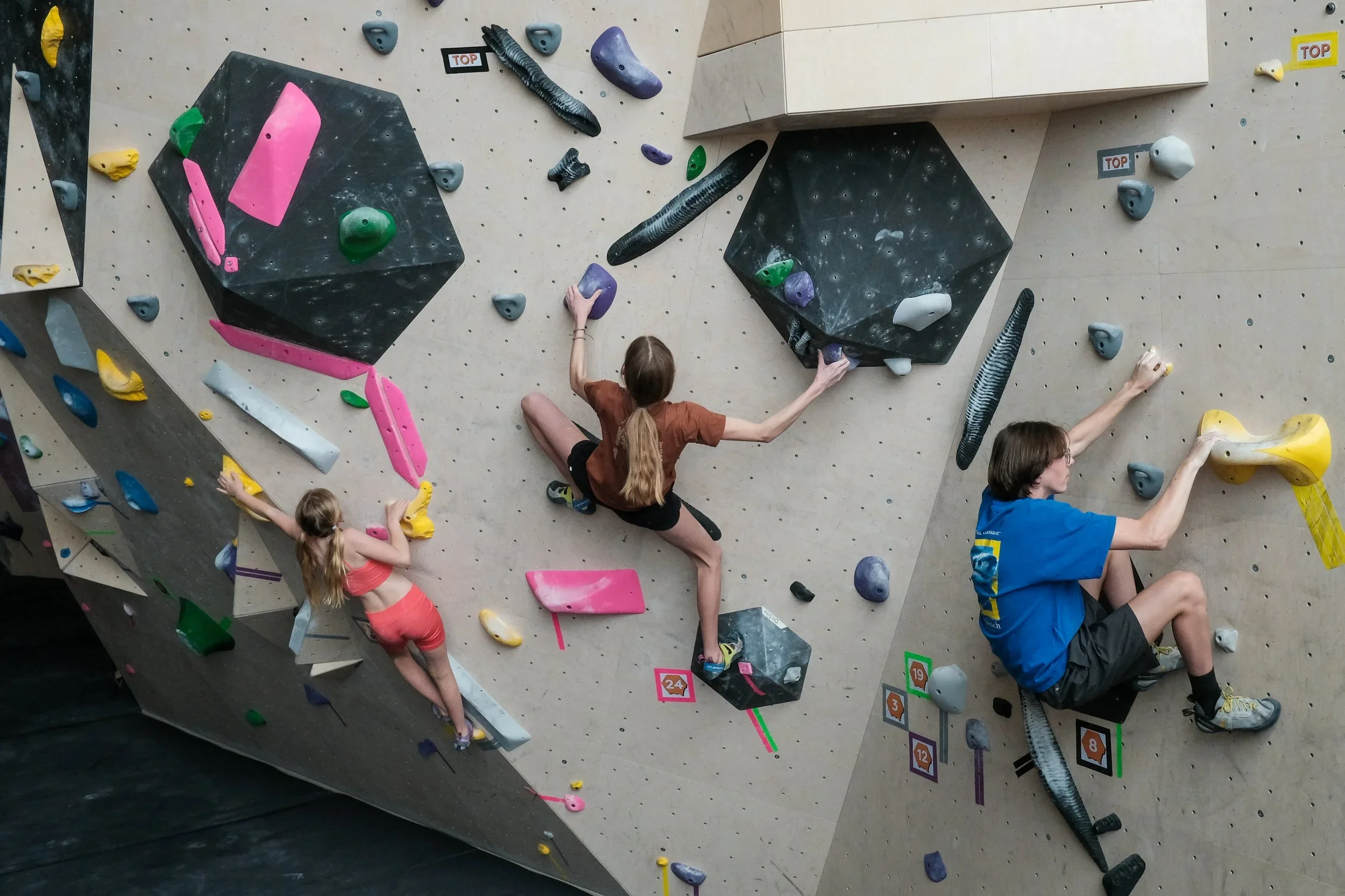 young kids on an indoor climbing wall