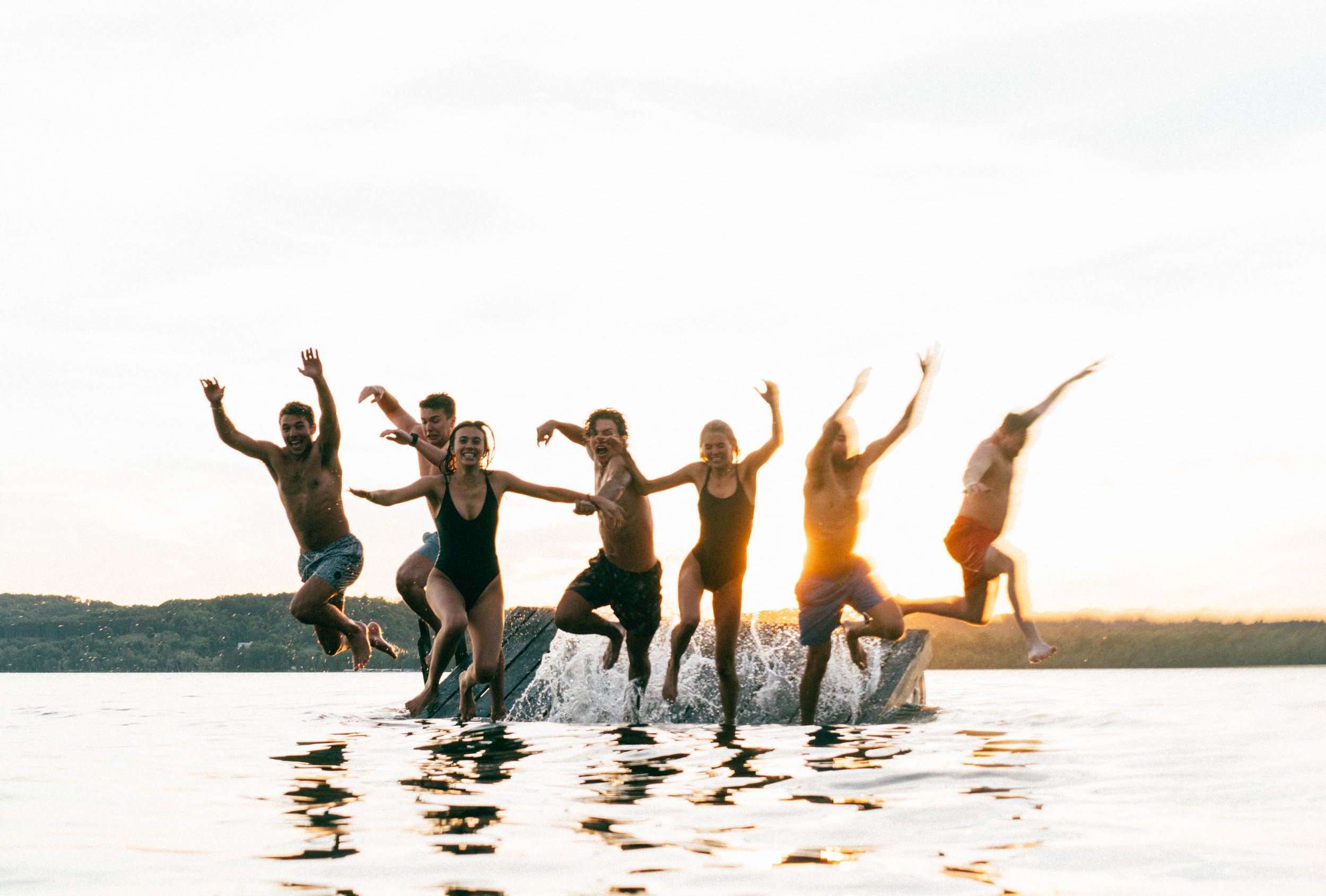 people jumping in lake