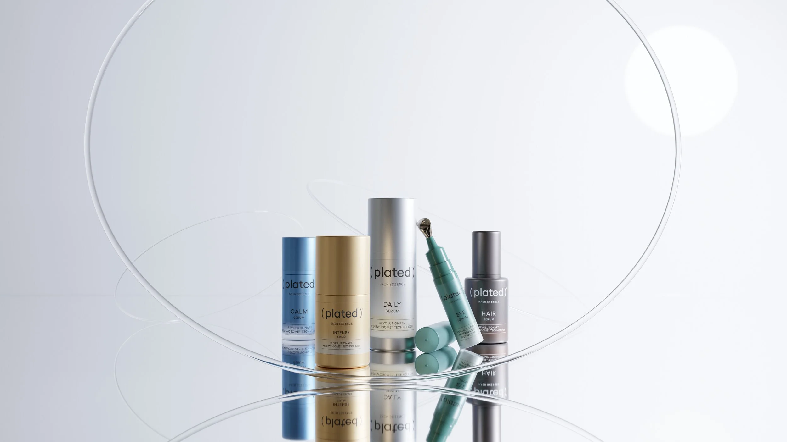 A collection of ( plated ) skincare products displayed elegantly, featuring various bottles and an eye applicator on a reflective surface.