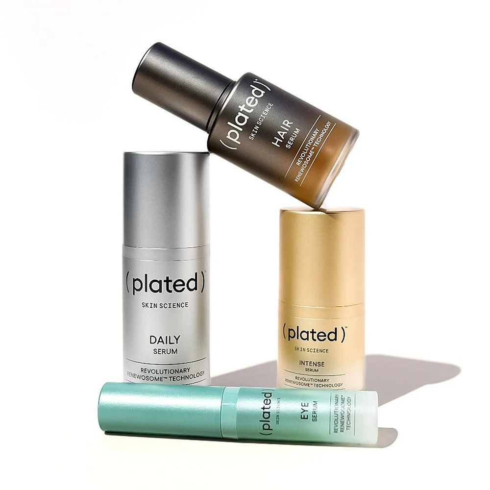 ( plated ) Skin Science product collection including INTENSE Serum, EYE Serum, HAIR Serum, and DAILY Serum bottles arranged on a white background