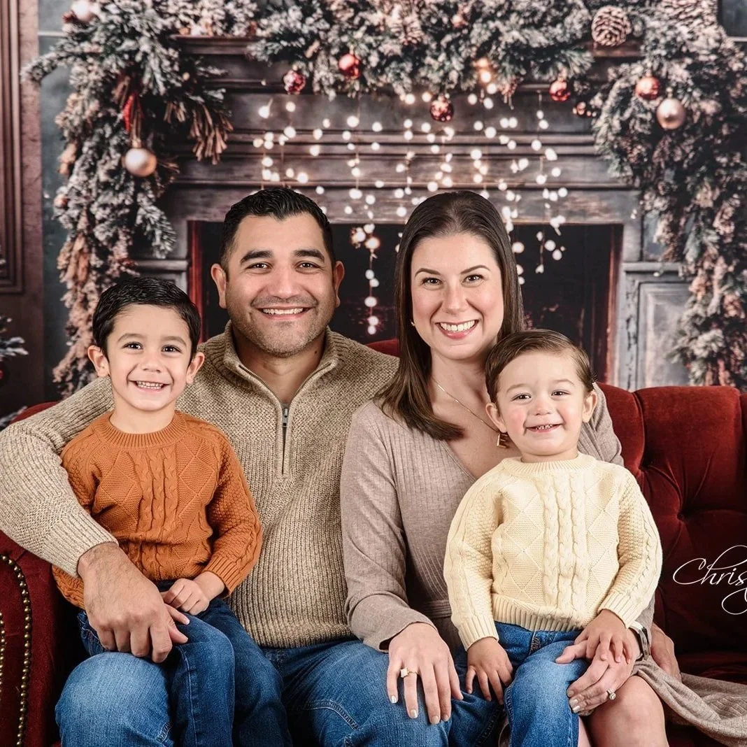 Family smiling during relaxed limited edition studio holiday photography session in Alvin Texas