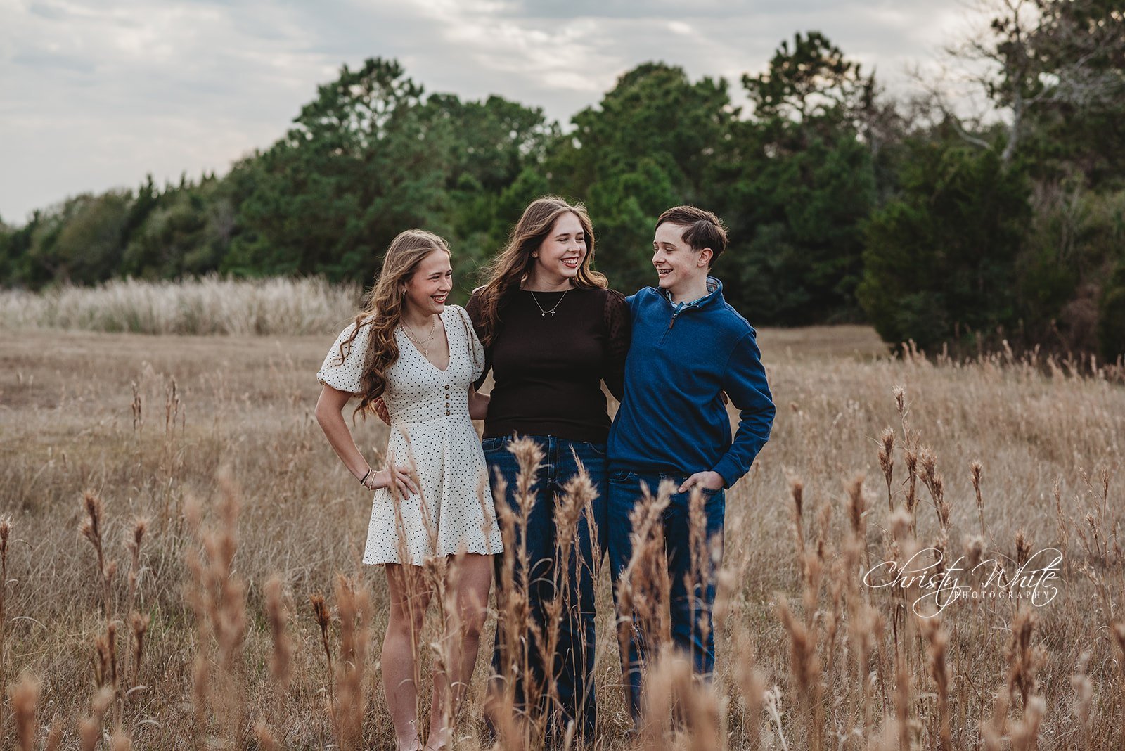 Children laughing naturally during limited edition seasonal photography session in Friendswood Texas
