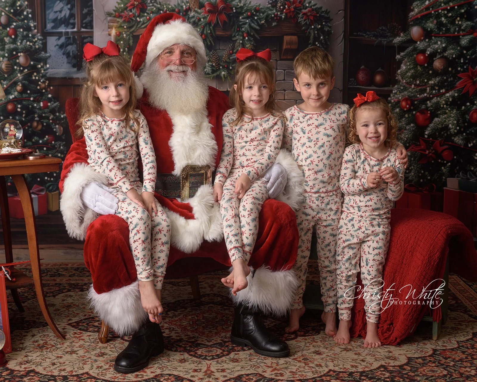 Children smiling during a traditional Santa picture with classic holiday portraits in Alvin, Texas.