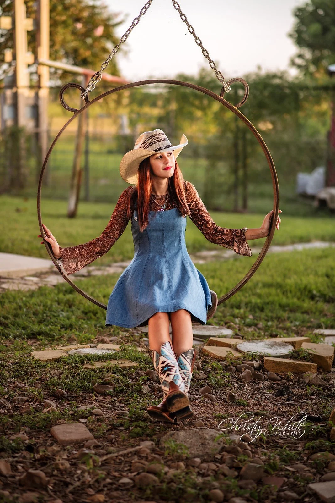 Kendal smiling in her cowboy hat during an outdoor senior portrait session