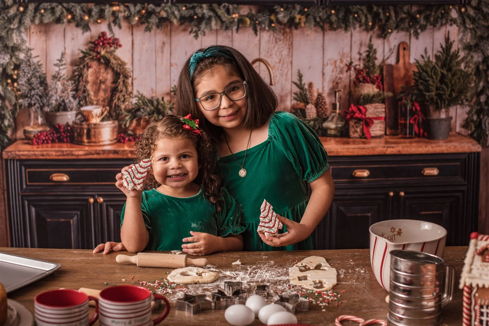 Siblings enjoy cookies in a Christmas kitchen