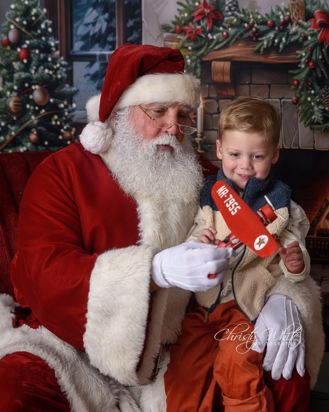 Candid Christmas portrait of a child spending time with Santa