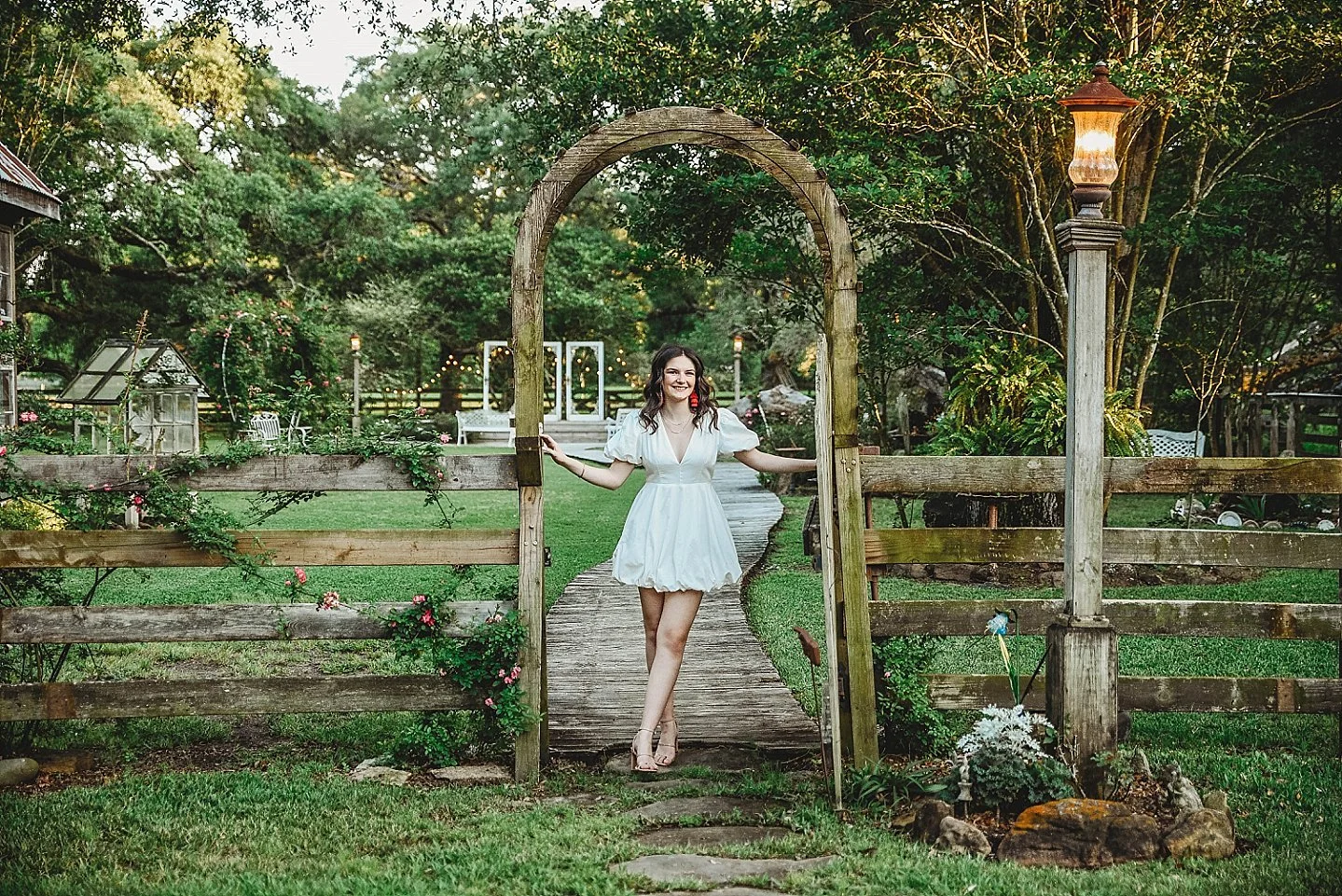 female high school senior smiling naturally during outside senior portrait session in Angleton Texas