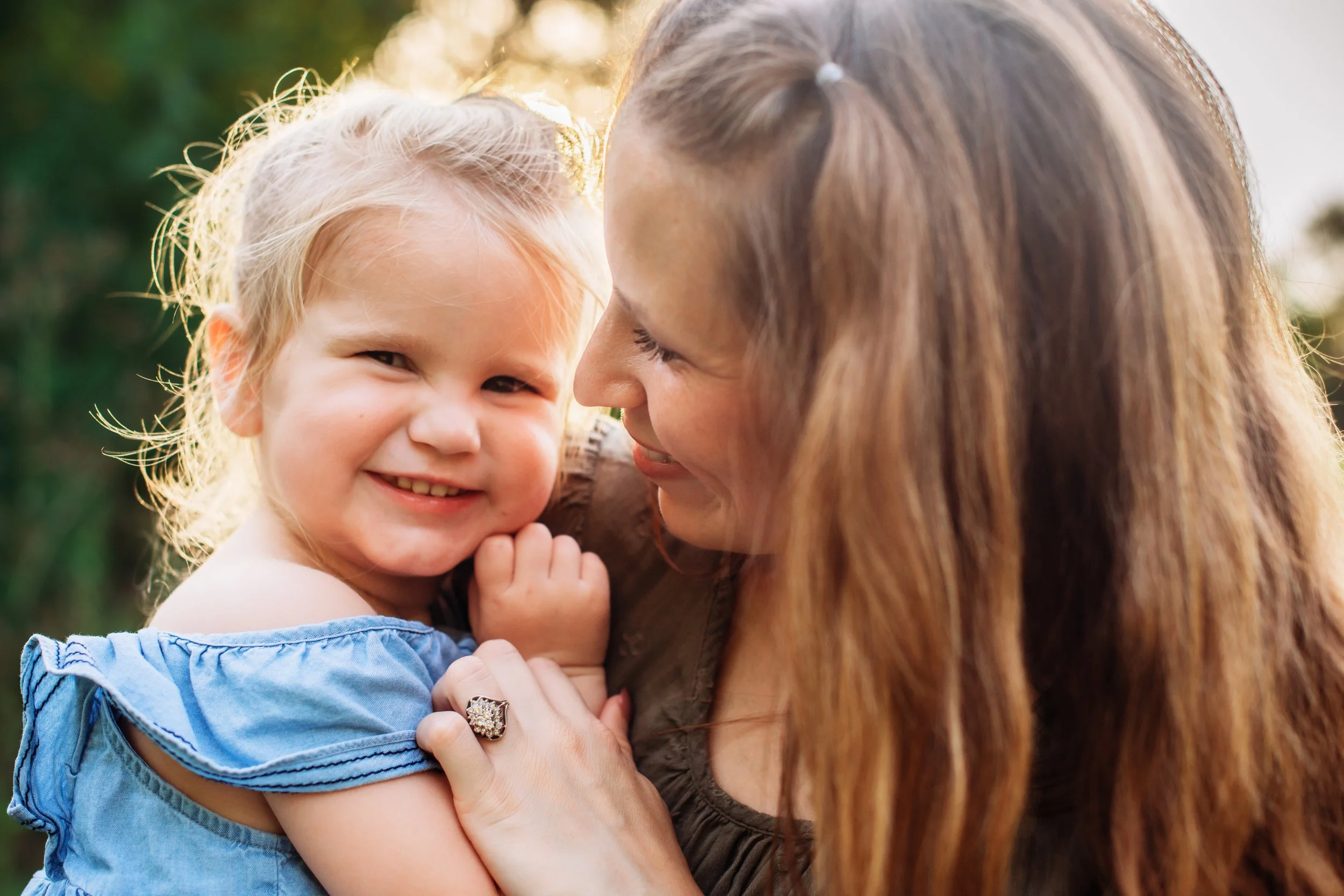 Mother and daughters together during a relaxed outdoor family session in Alvin, Texas.