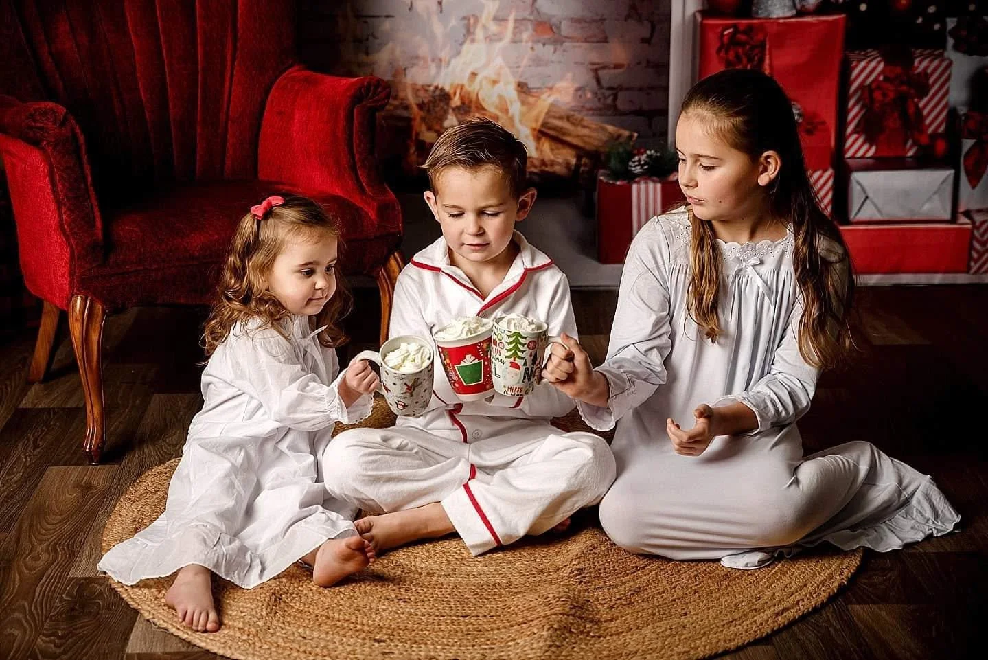 siblings drinking hot cocoa on a vintage storybook Christmas set