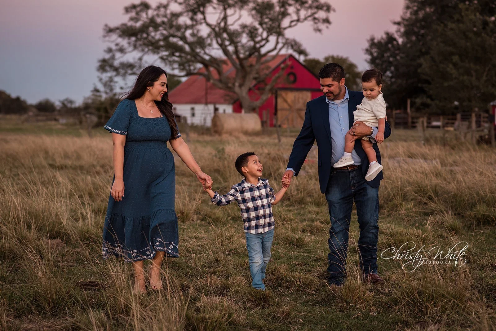 Family laughing together during relaxed natural outdoor family photography session in Pearland Texas