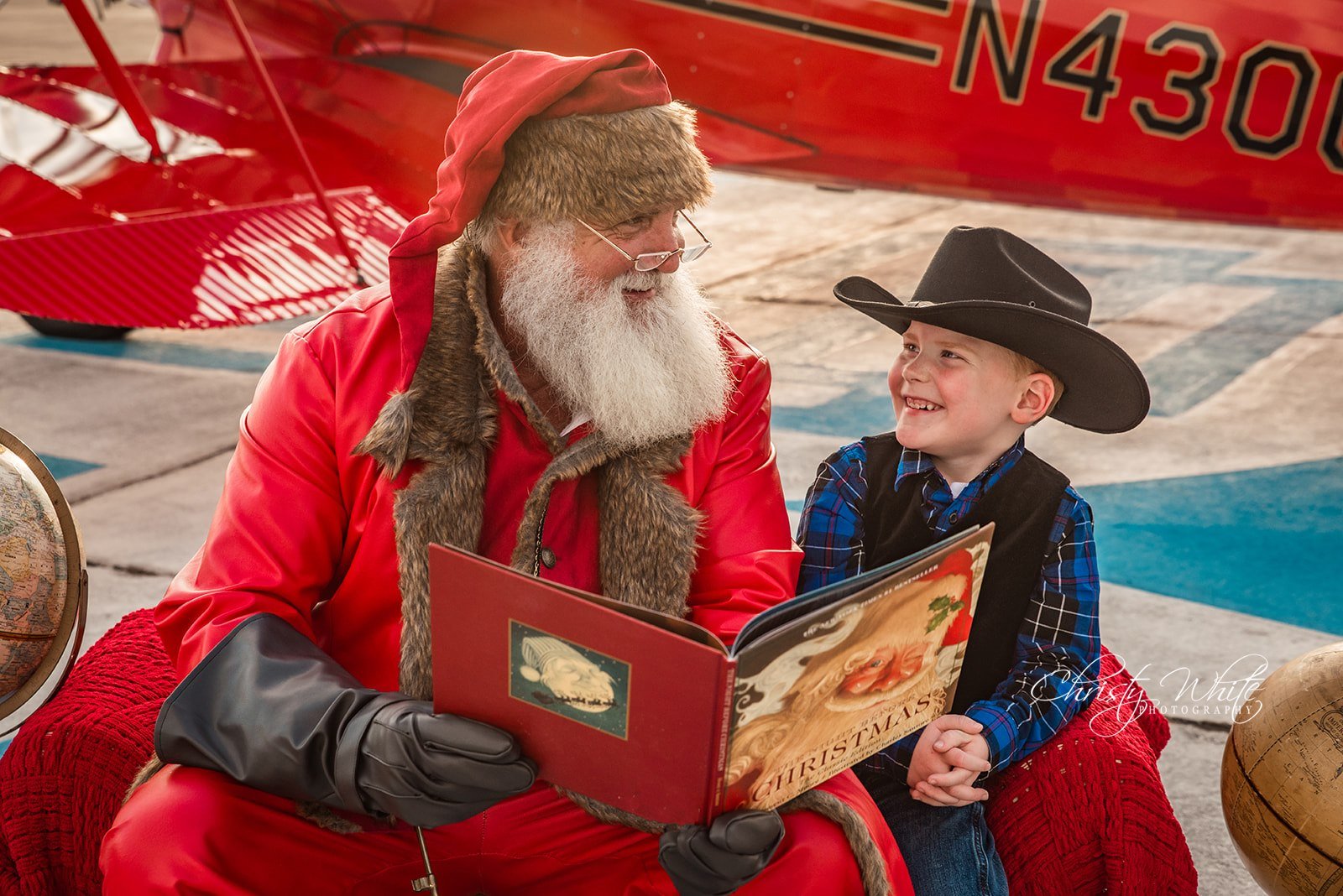 Santa sharing Christmas Magic with a young child in Galveston by airplane.