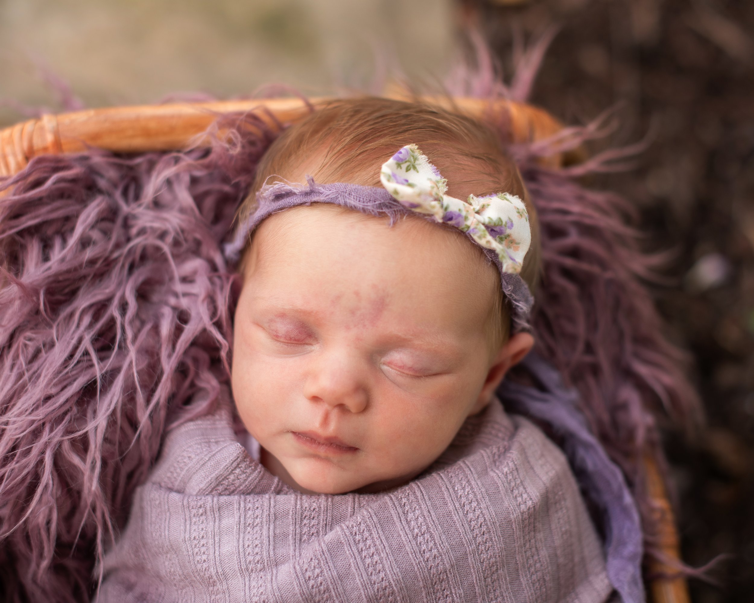 Parents holding their newborn during a relaxed outdoor family photography session near Houston, Texas.