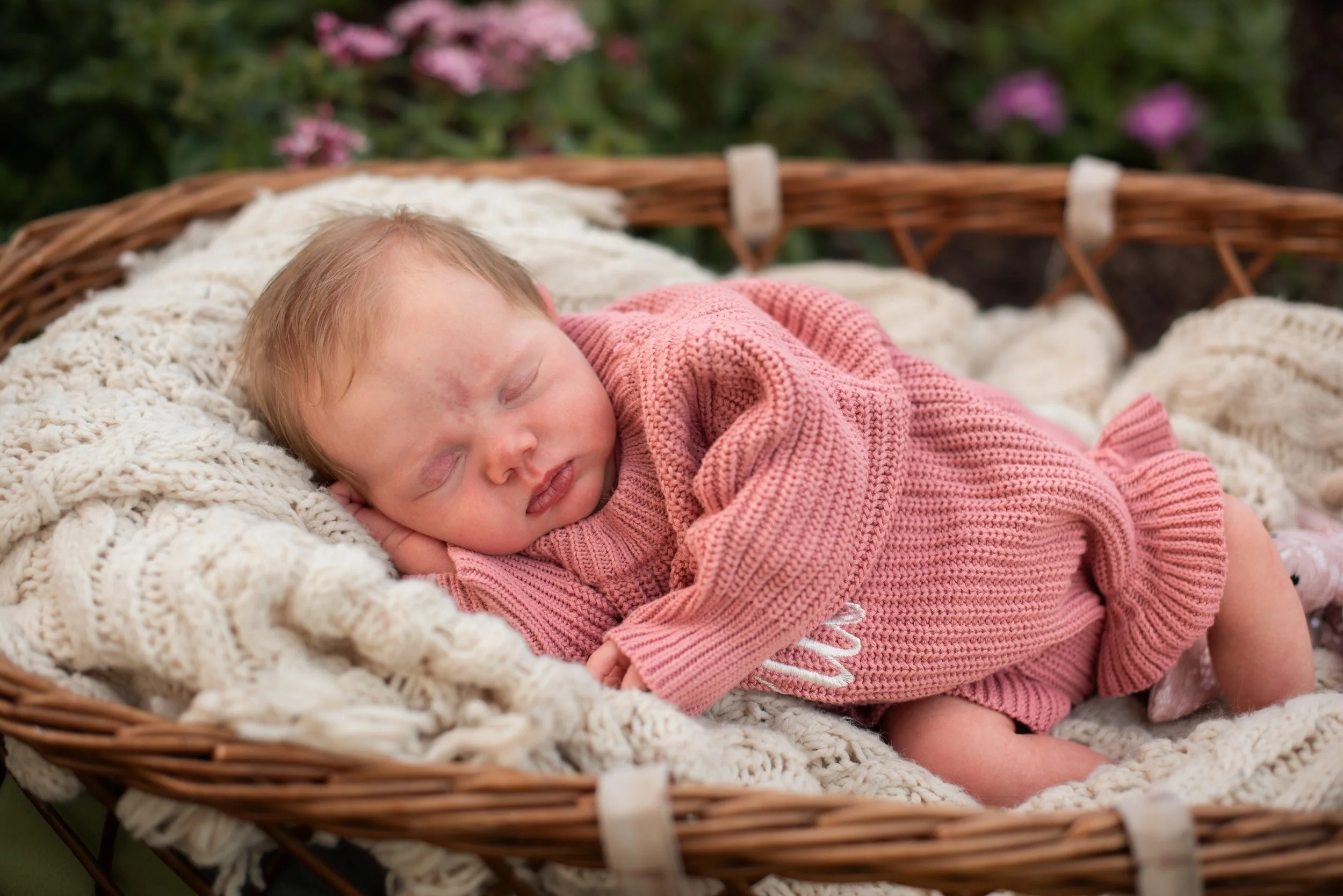 Lifestyle newborn photography capturing authentic family moments in a beautiful outdoor setting near Houston.