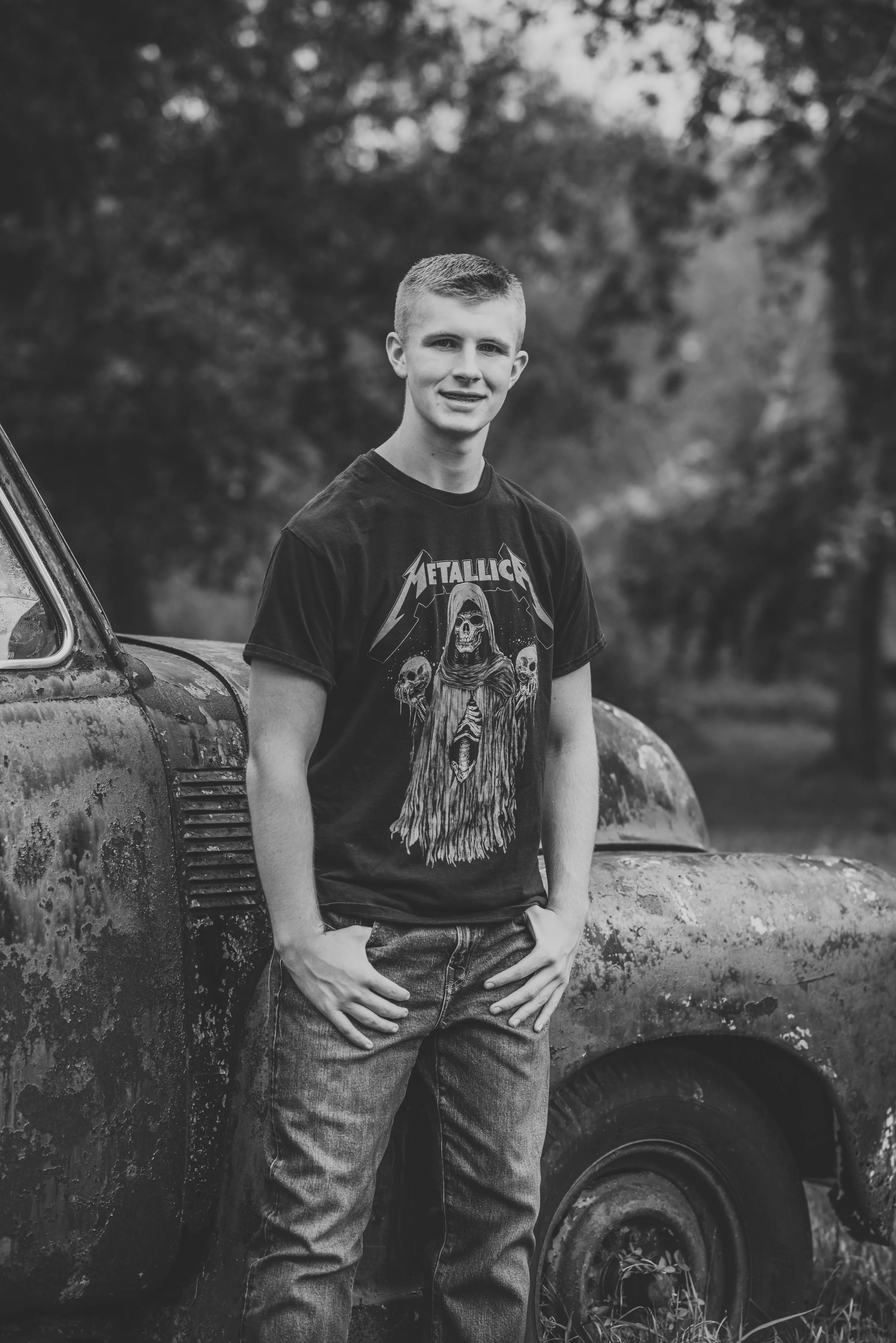An Alvin High School senior at a rustic, country session with a vintage truck