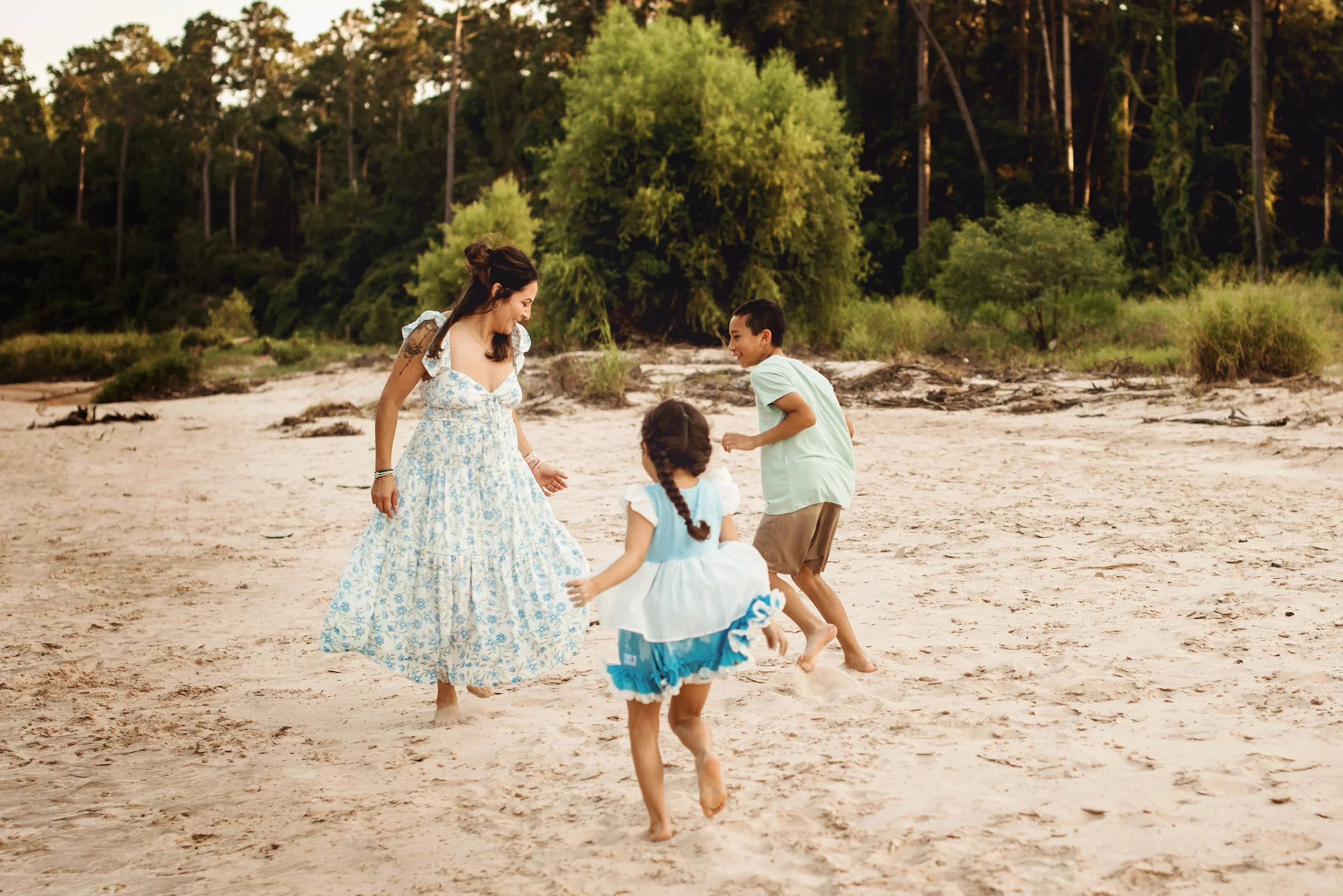 Authentic family photography capturing a mother and her children enjoying time together outdoors.
