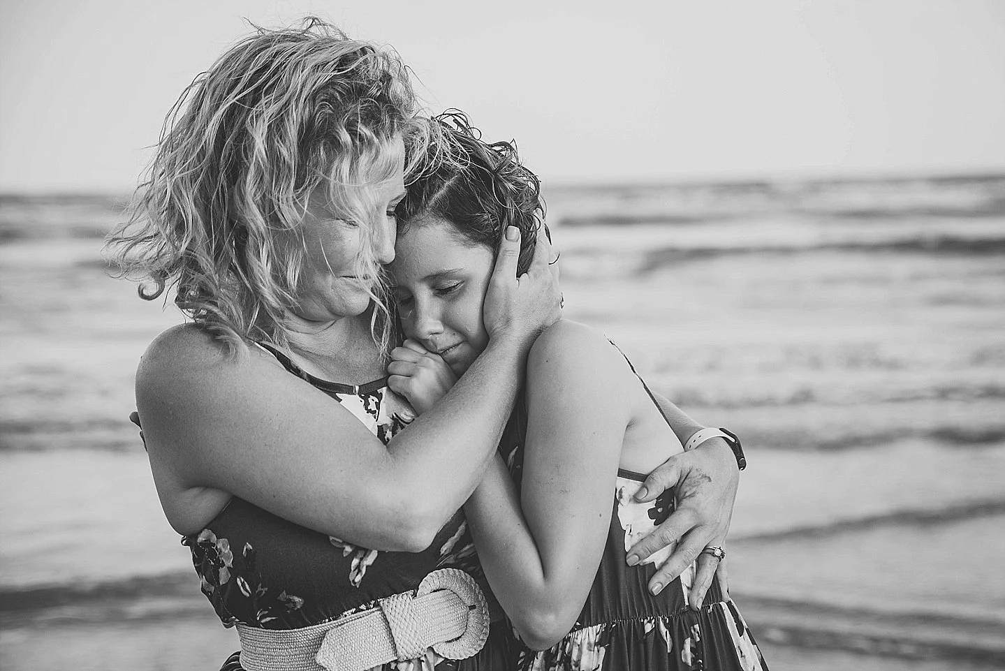 a mom and daughter enjoy their time together on the beach