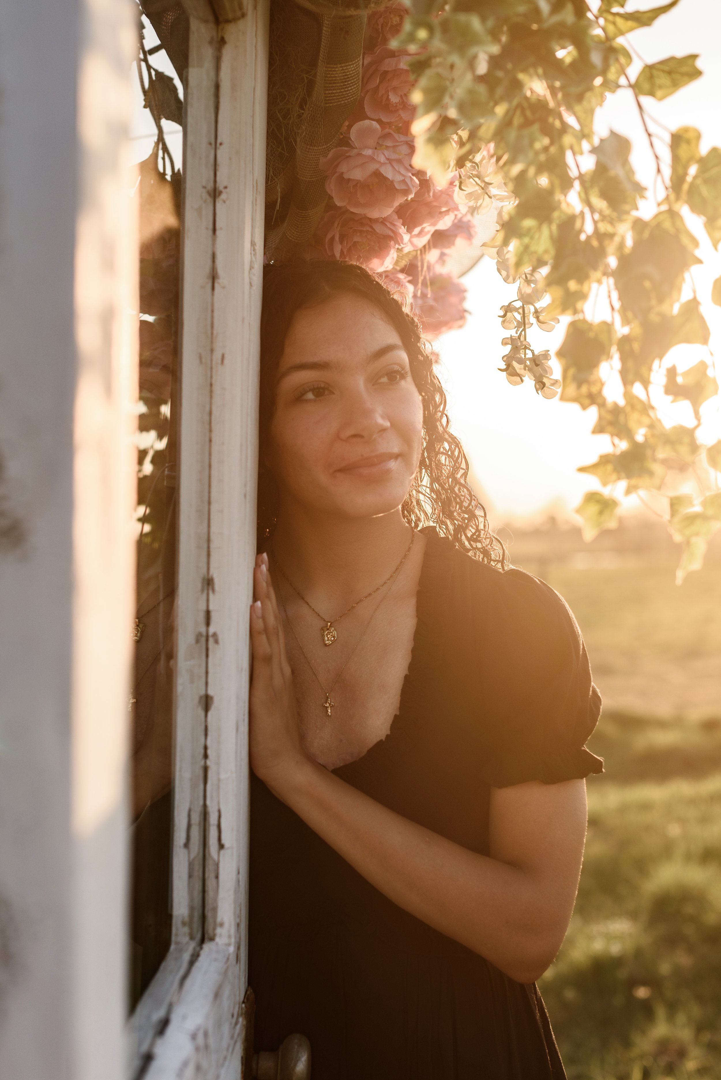 A senior girl with florals at sunset
