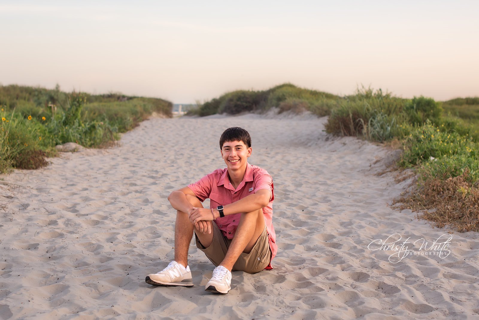 Senior boy photographed near the dunes during a Galveston beach senior session