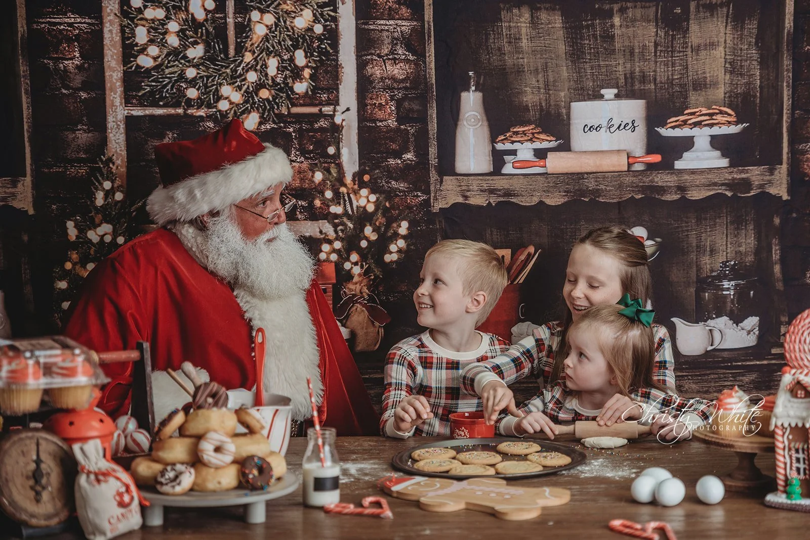 Family sharing a joyful Christmas moment with Santa during a professional holiday photography session in Alvin, Texas.