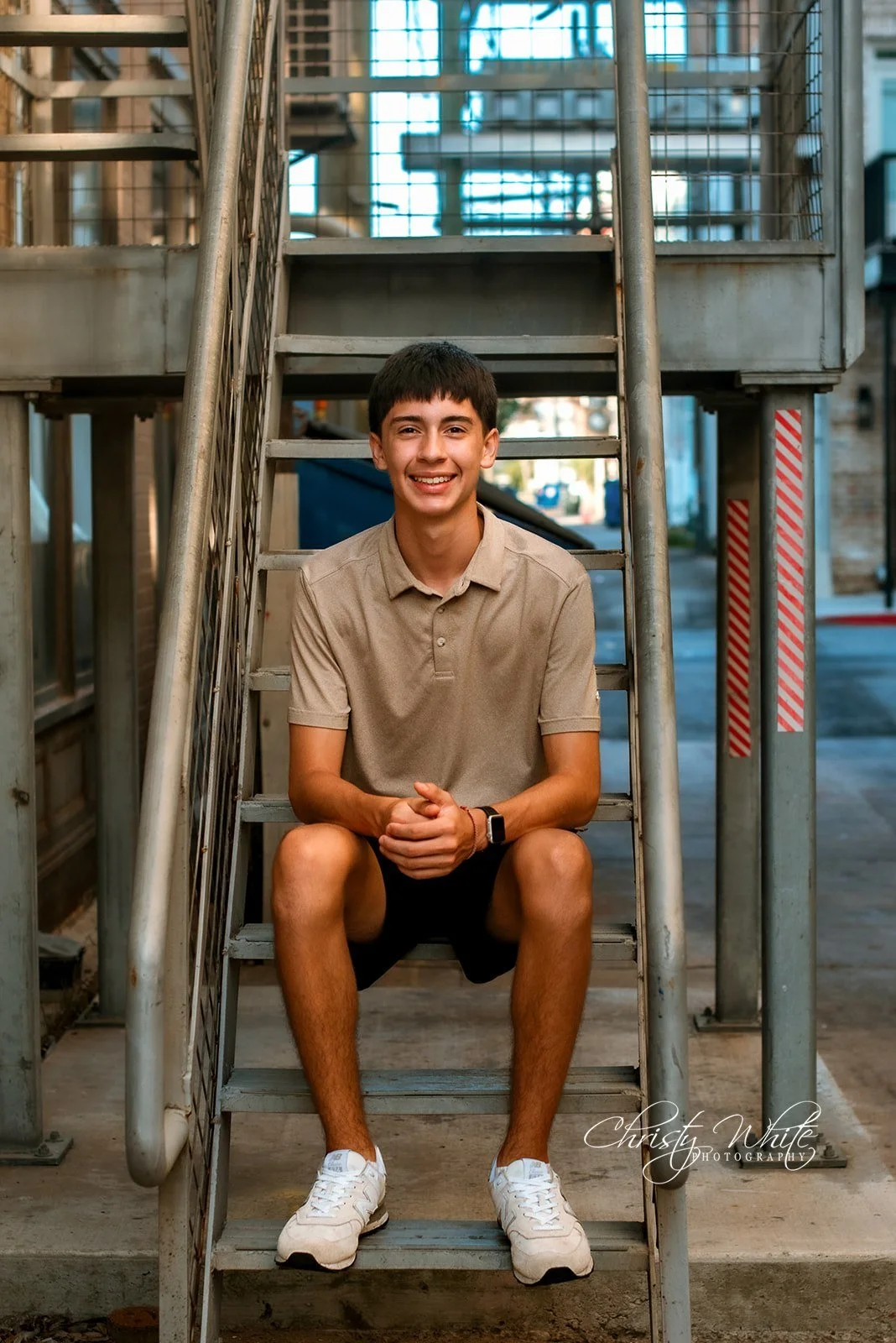 Alvin High School Class of 2027 senior photographed in an urban setting on the Galveston Strand