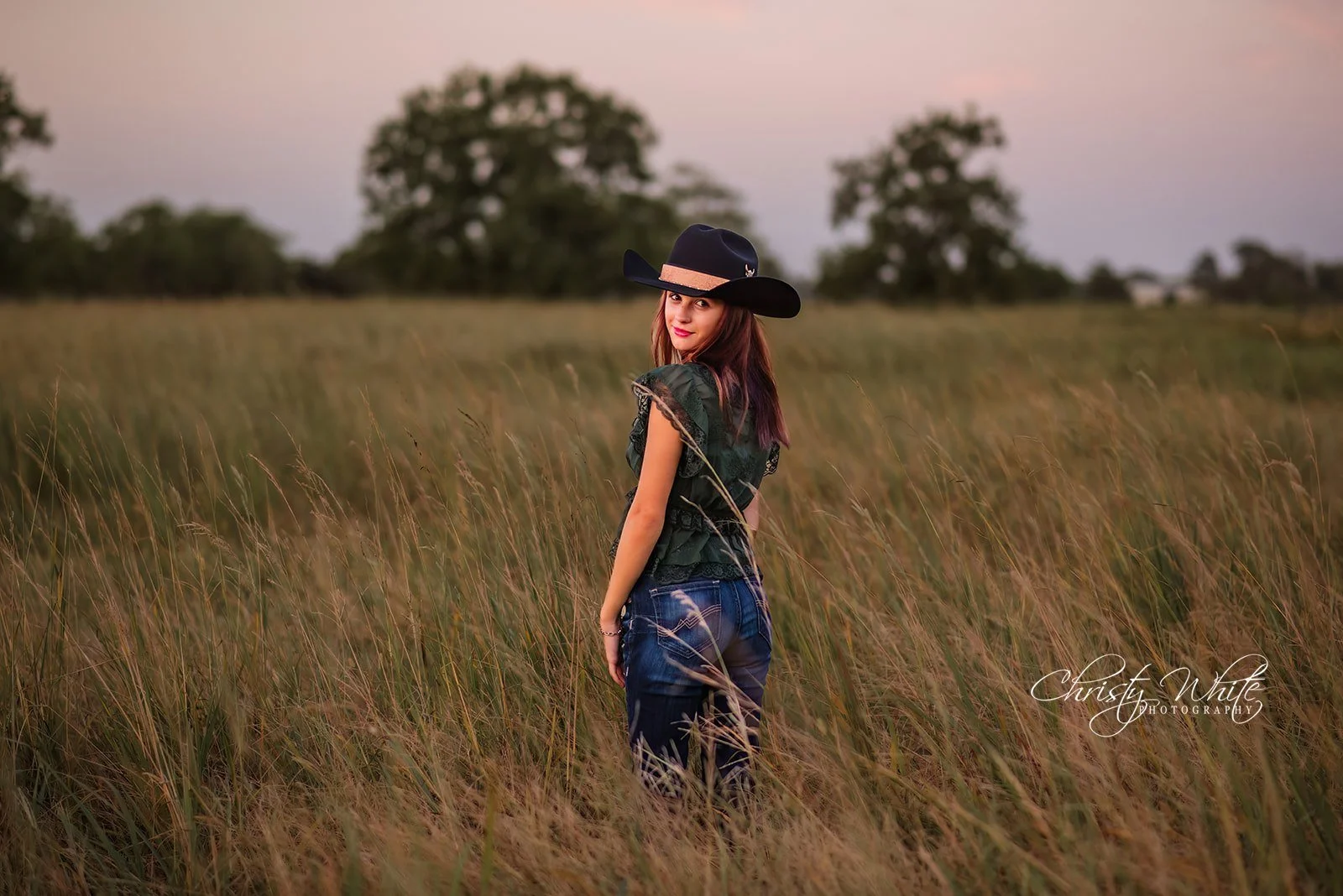 Kendal wearing a cowboy hat during her rustic Texas senior photography session