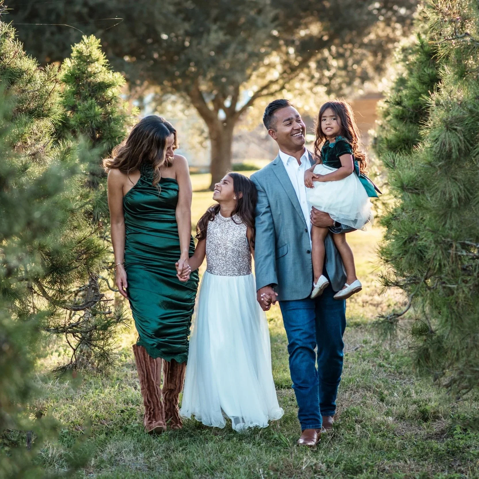 Family laughing together during relaxed natural outdoor family photography session in Manvel Texas
