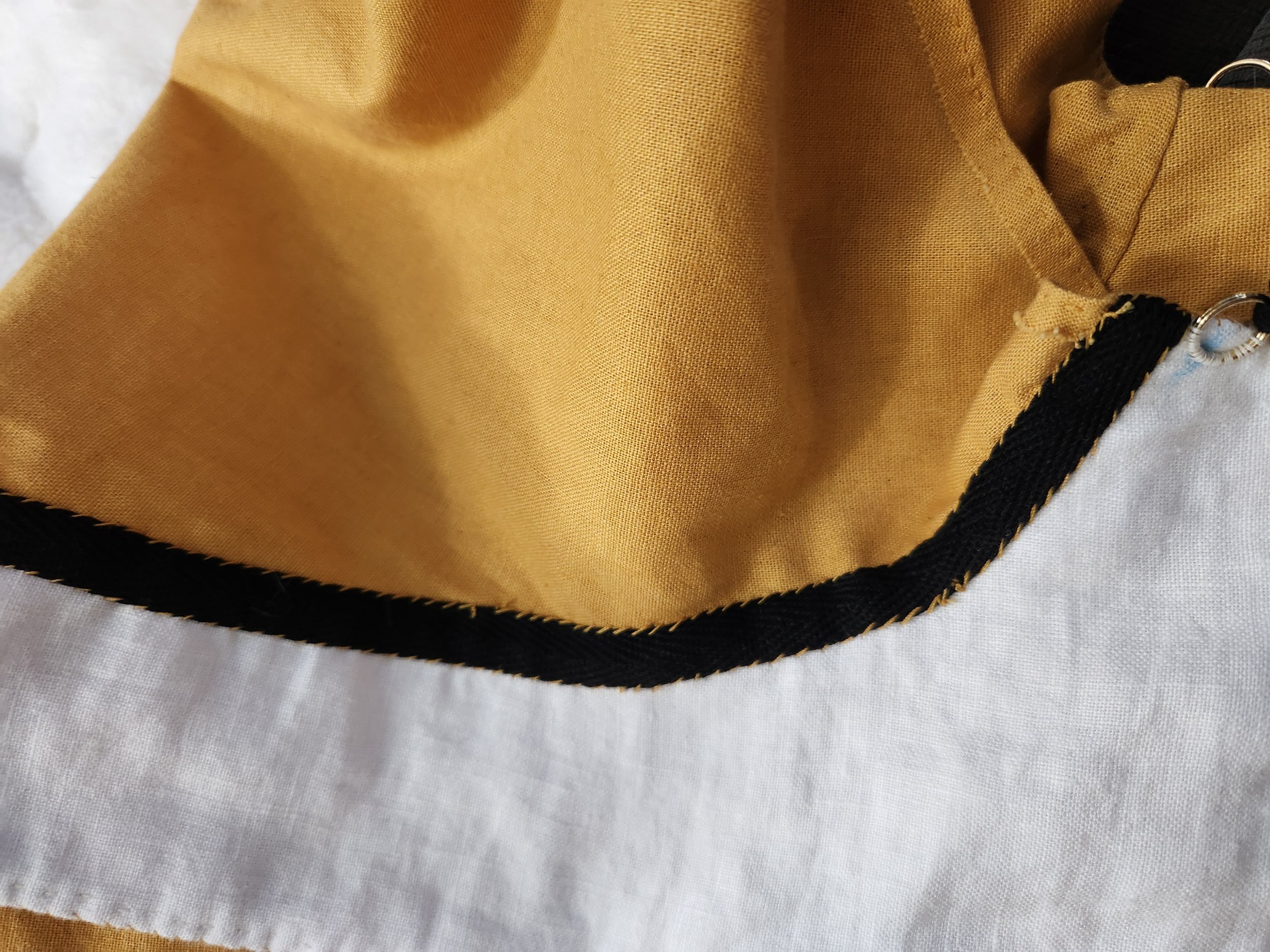 Twill tape covering at the armscye.
