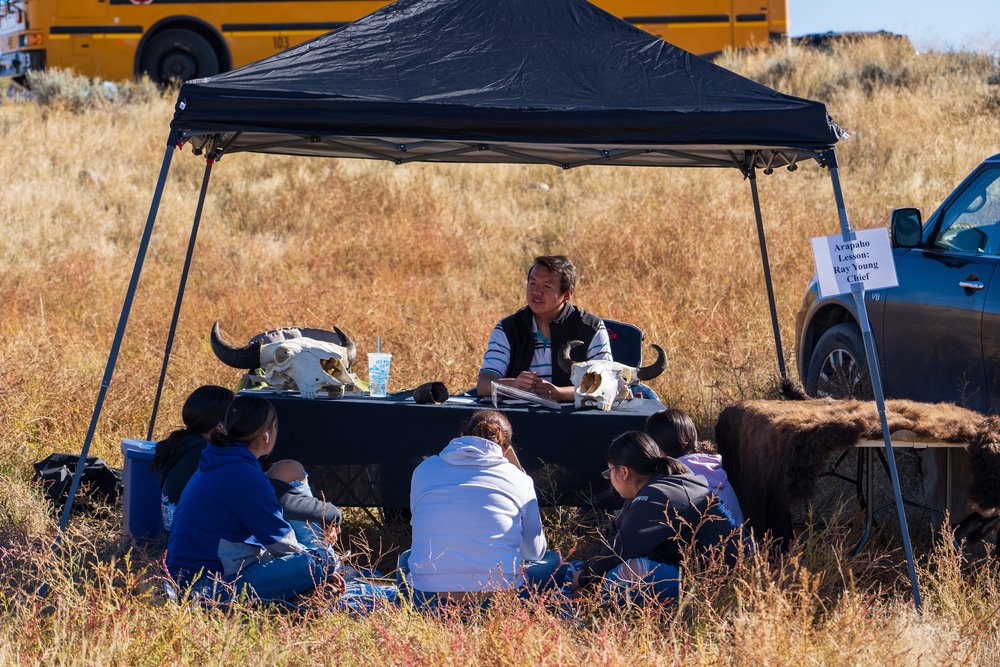  Students learn about bison at the Arapaho lesson station from Ray Young Chief. (Photo GYC/London Bernier) 