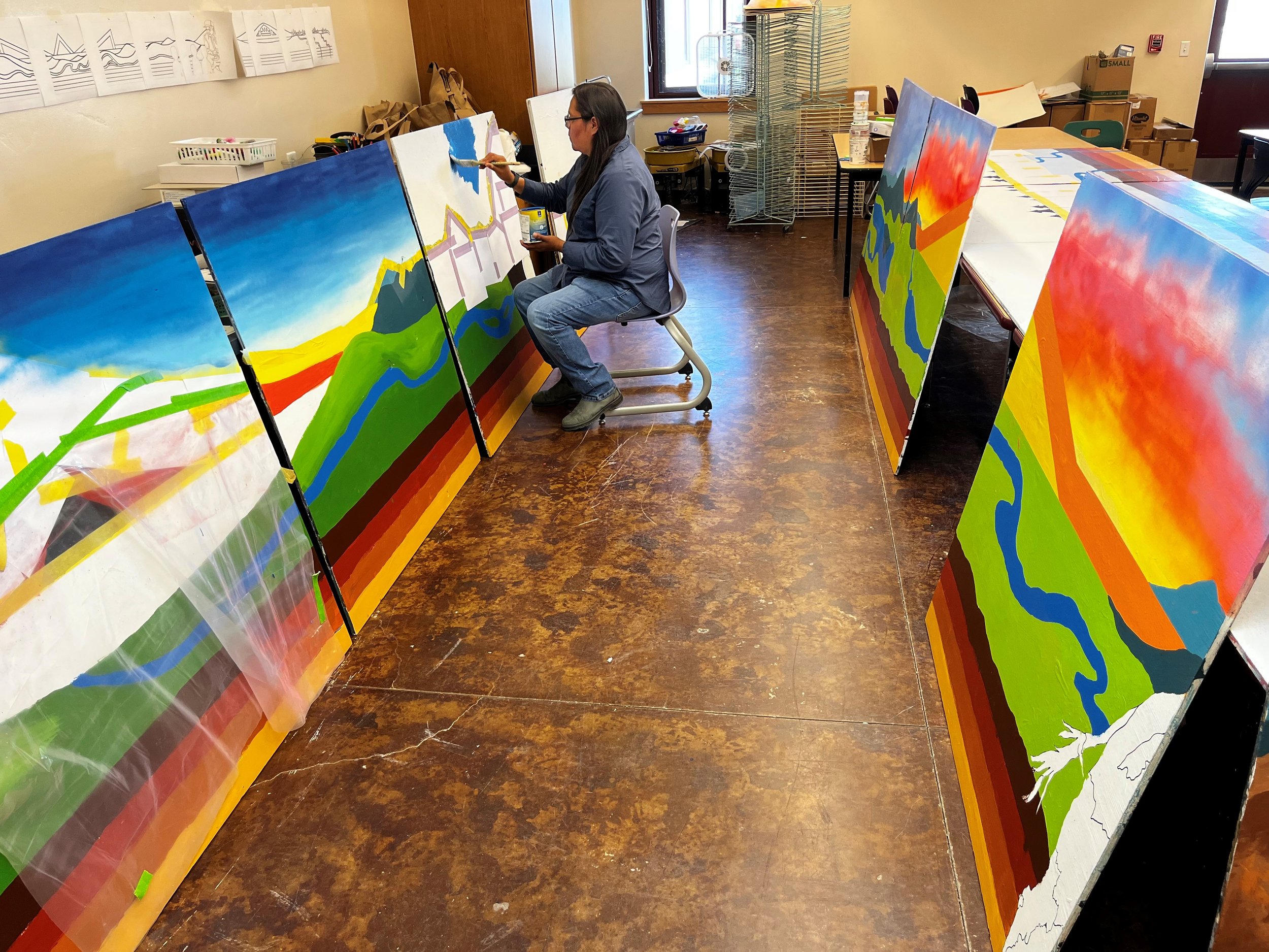  GYC Wind River Conservation Organizer Colleen Friday paints the in-progress mural. (Photo Adrienne Vetter) 