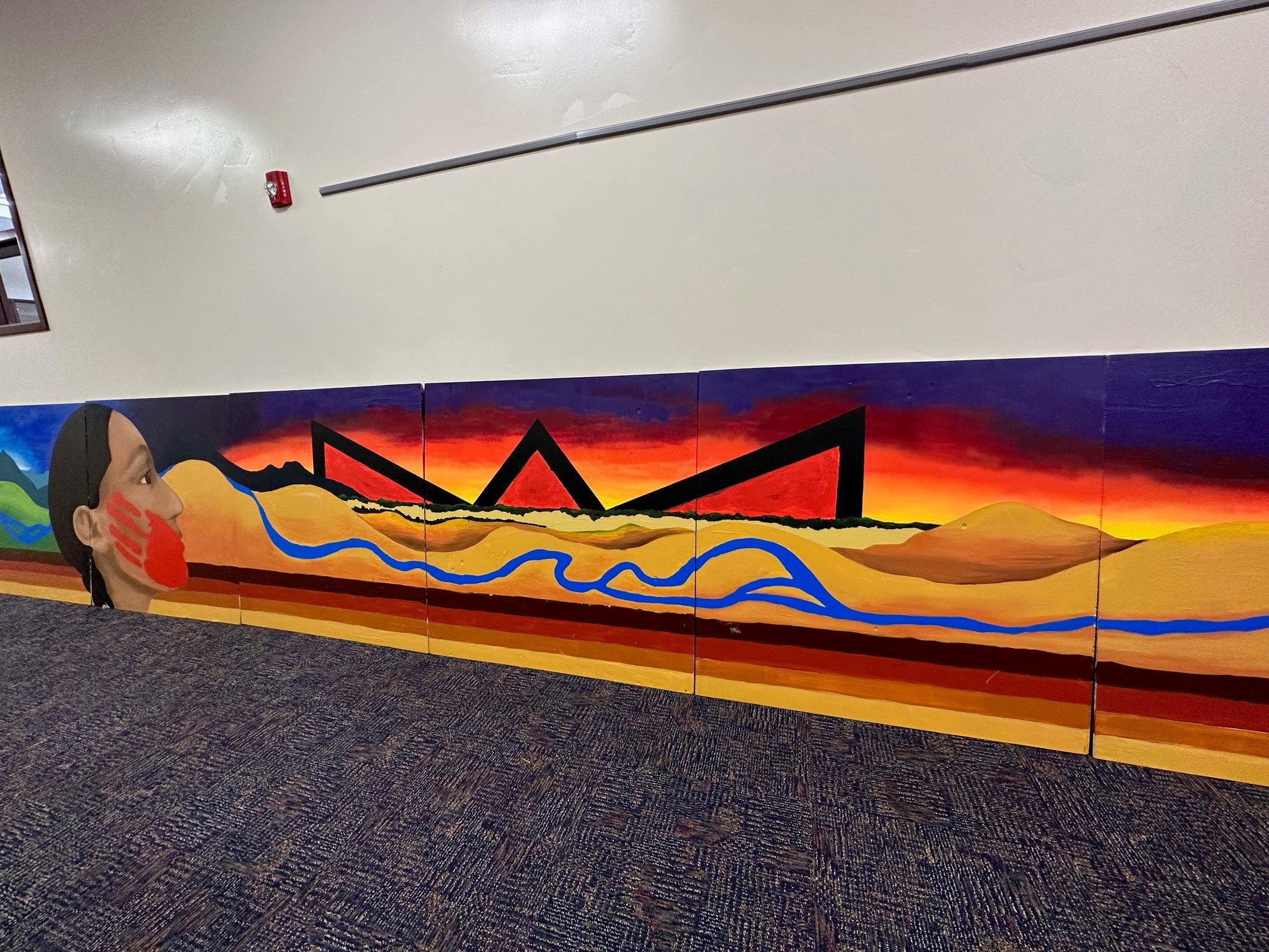  The third panel of the mural depicts the third Arapaho hill of life, adulthood, which is associated with the color black and the direction of west. (Photo Colleen Friday) 