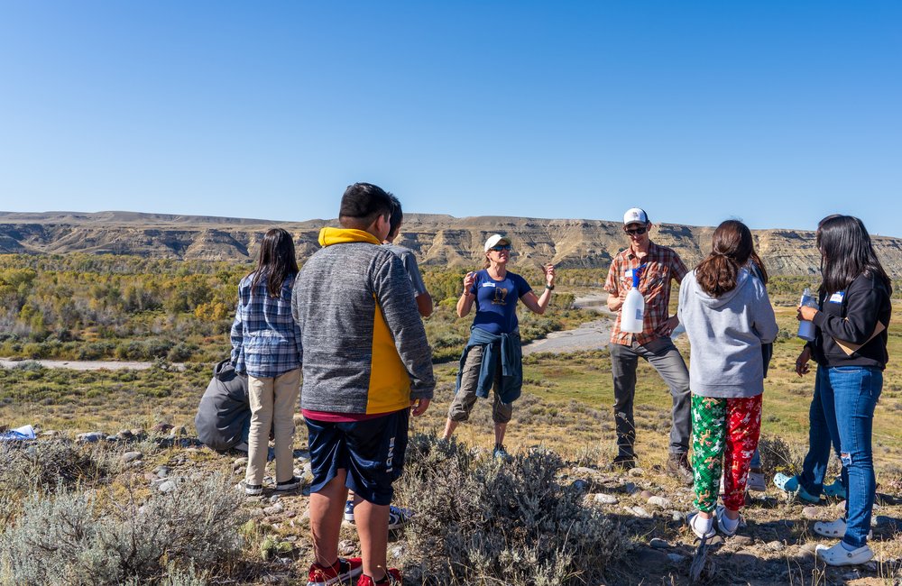  Students learn about water and drought with GYC’s Climate Conservation Coordinator Sierra Harris and Senior Climate Conservation Associate Kurt Imhoff overlooking the Big Wind River. (Photo GYC/London Bernier)   