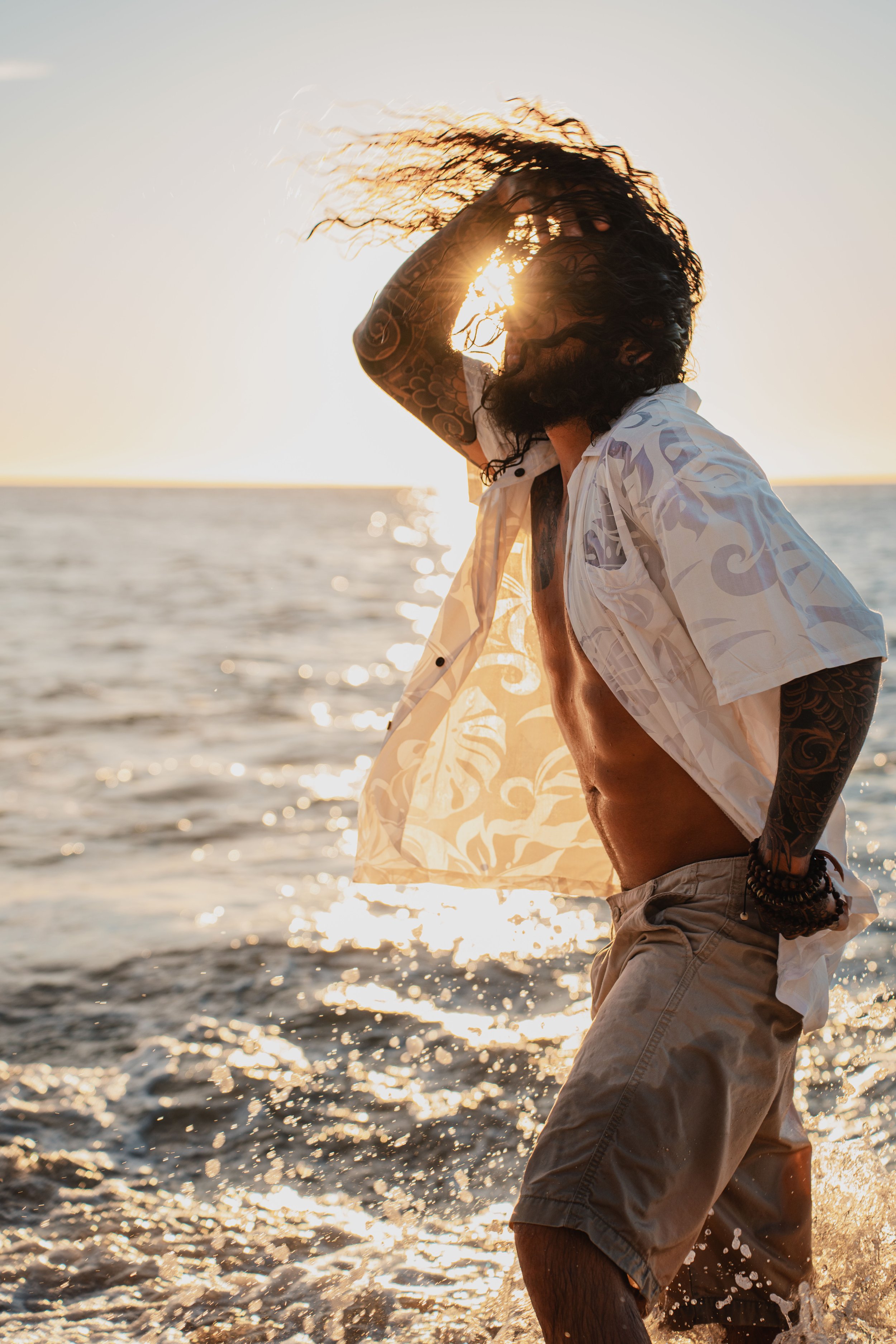 Male flipping hair back while in the water during a photoshoot at Oahu, Hawaii 