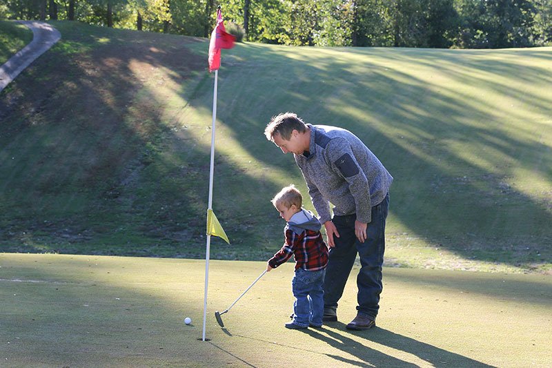 Father and Son Golfing at the Rustic
