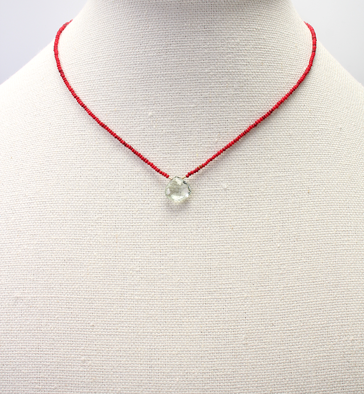 Handmade necklace with green amethyst briolette on red coral beads, gold filled clasp, and green silk tassel