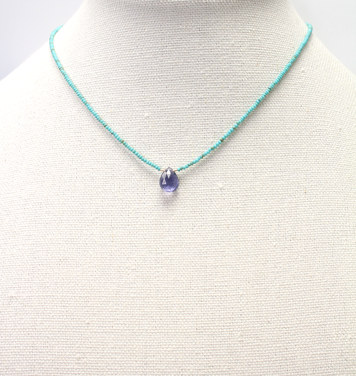 Handmade necklace featuring an iolite briolette on turquoise beads with a gold filled clasp.