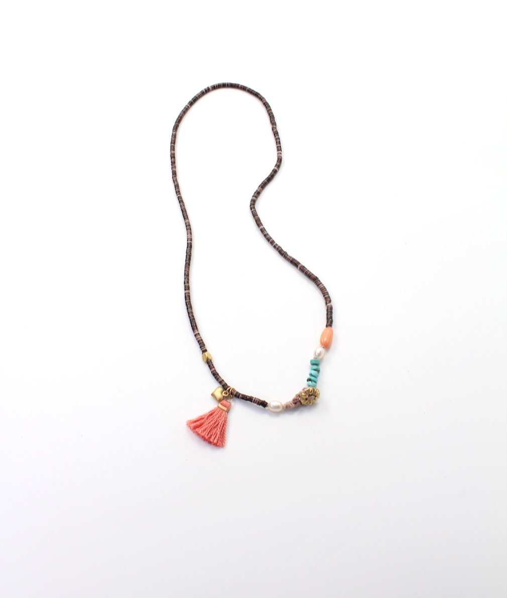 Shell heishi bead necklace with knotted turquoise, coral, pearls, gold-filled heart charm, button clasp, crochet loop, and coral silk tassel.
