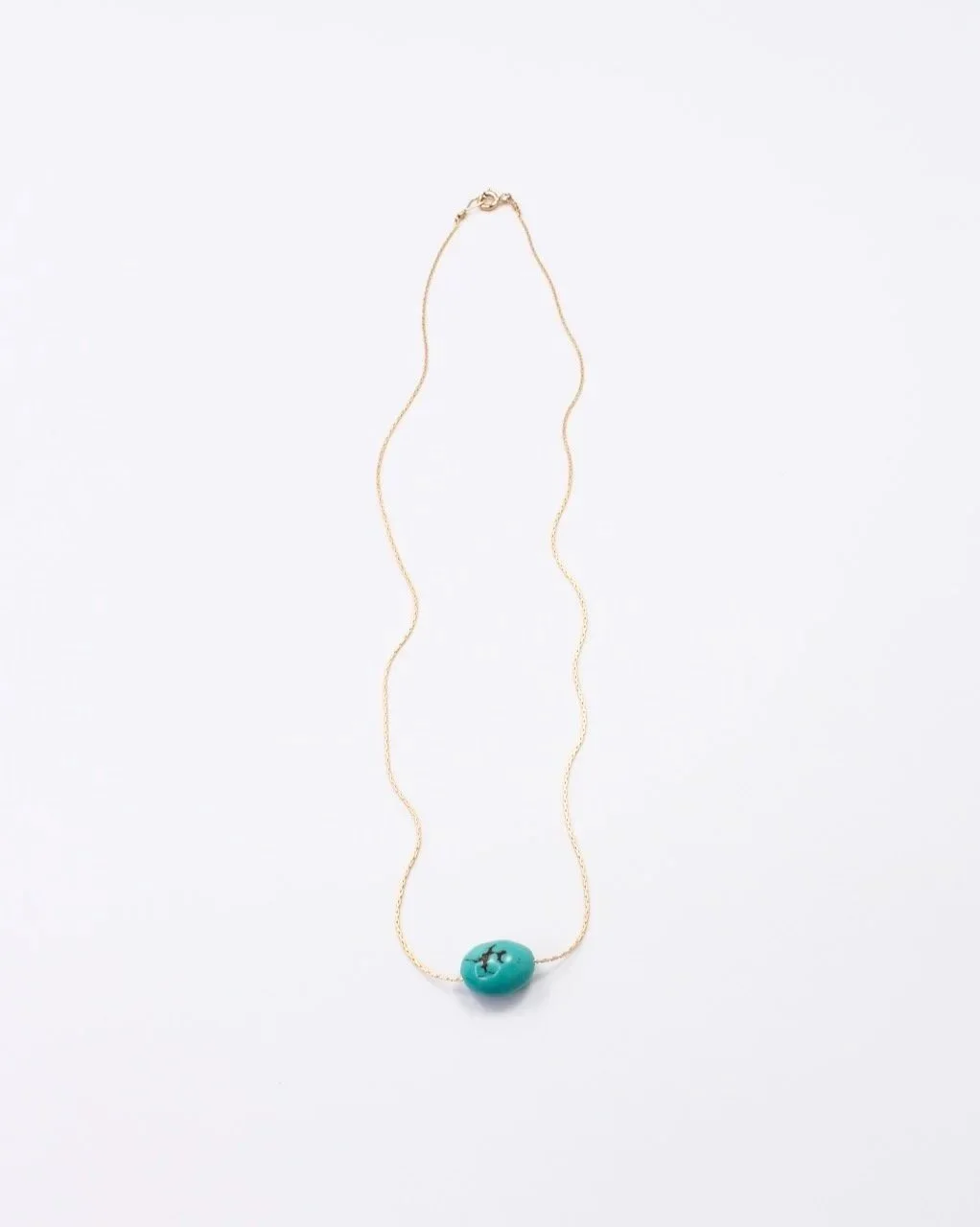 Floating turquoise gemstone necklace on a gold-filled chain with clasp, minimalist jewelry style