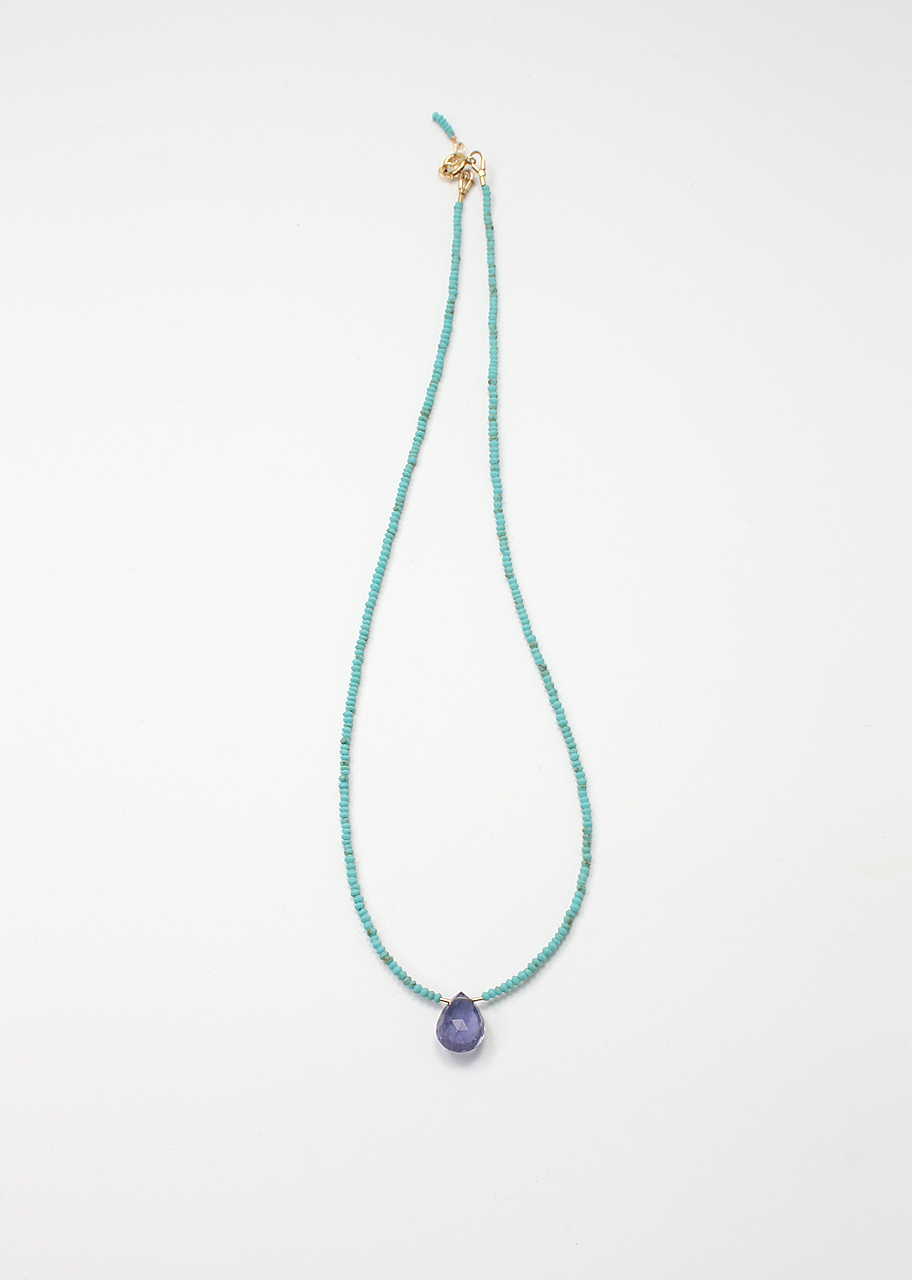 iHandmade necklace featuring an iolite briolette on turquoise beads with a gold filled clasp.