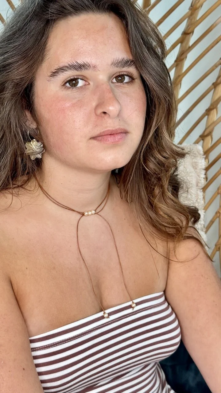 Gold filled hoop earrings featuring delicate mother of pearl flower charms.