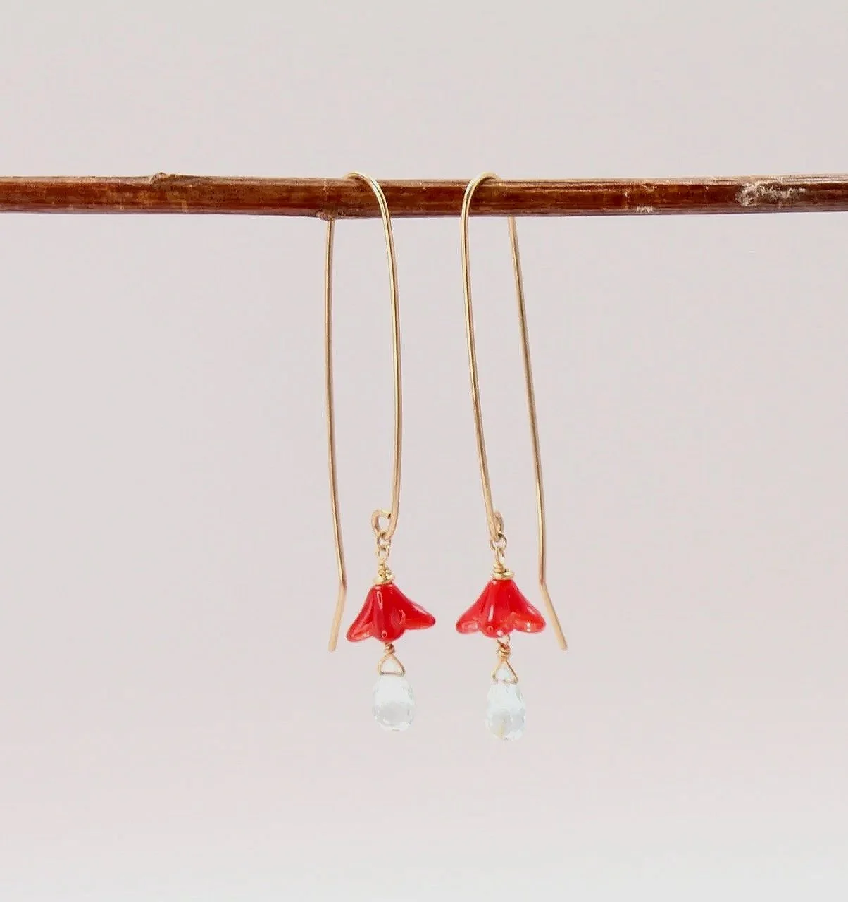 Gold filled earrings with red glass flowers and aquamarine gemstone accents.