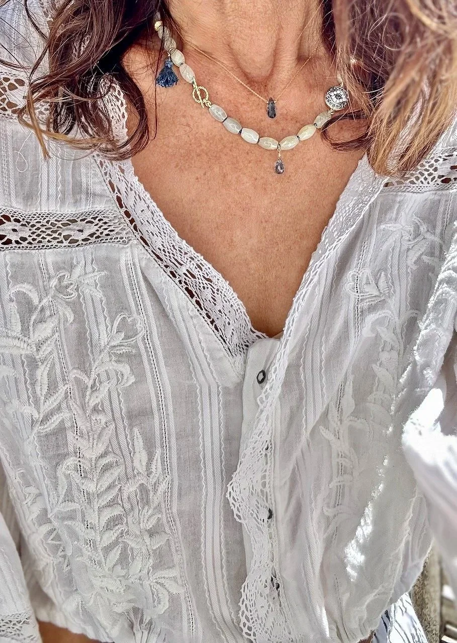 Hand-knotted aquamarine necklace with London blue topaz accents, crystal evil eye charm, vermeil clasp, and blue silk tassel.