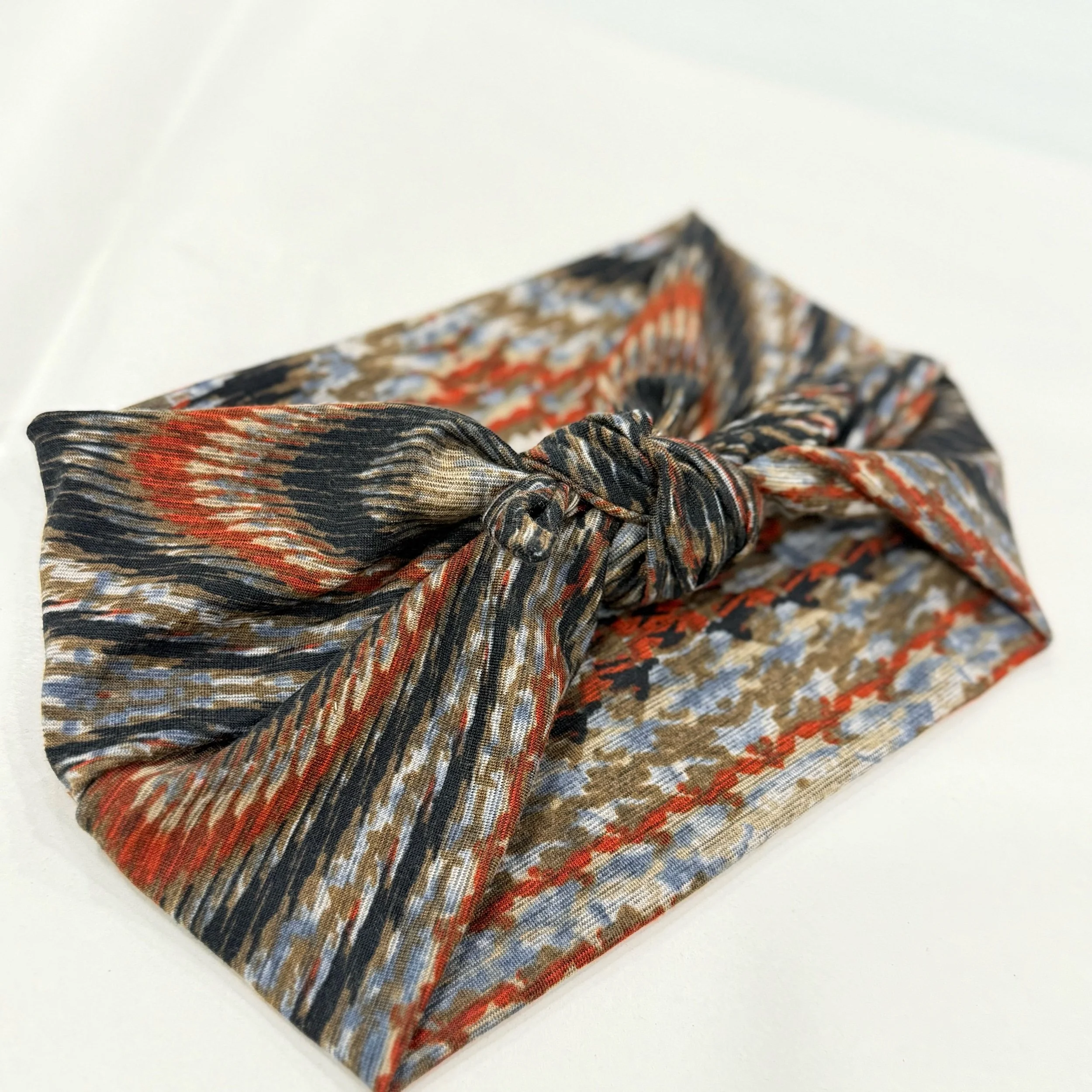 Adjustable muted wood grain stretch  fabric headband with colorful printed design, handmade by Seams by Sarah