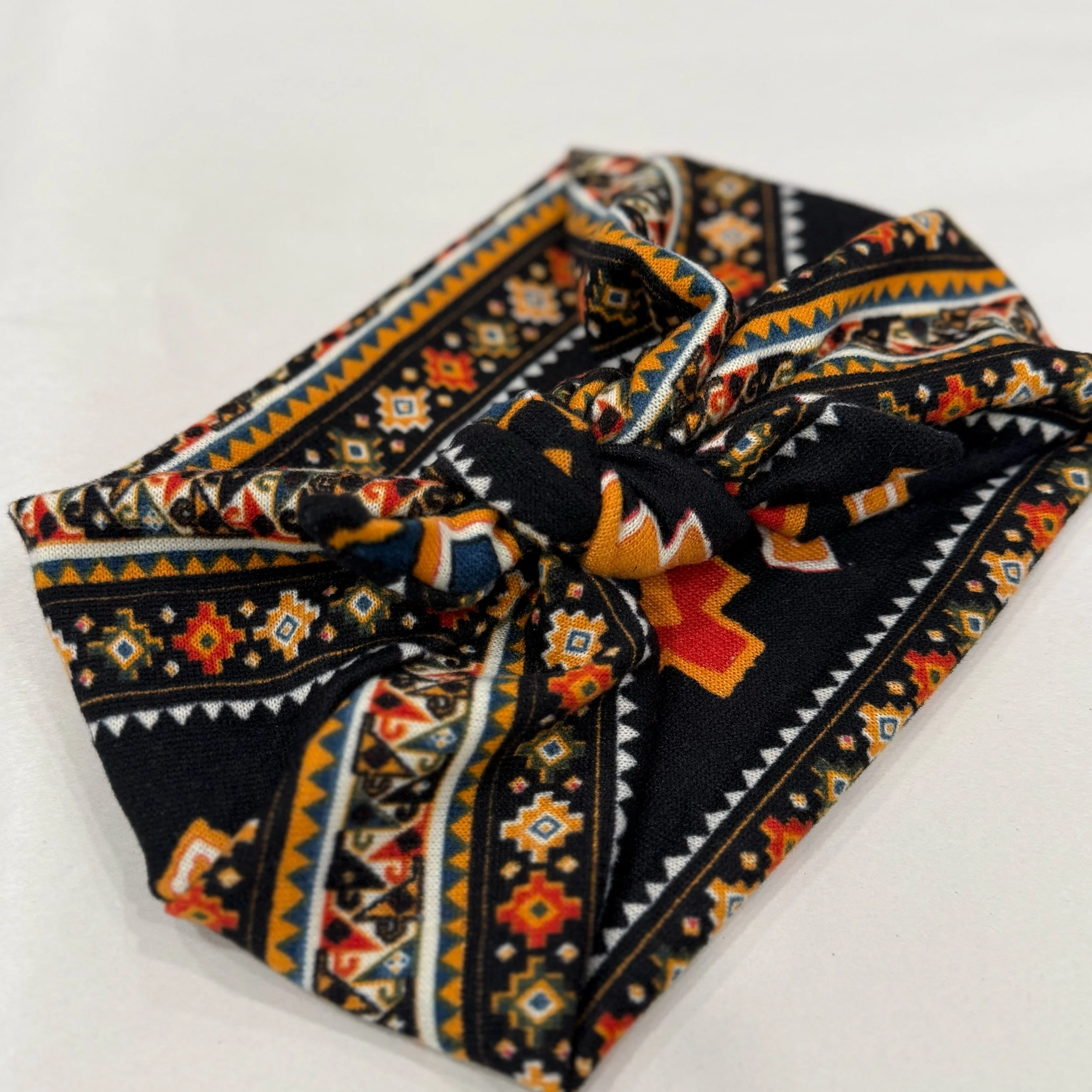 Adjustable southwest knitted fabric headband with colorful printed design, handmade by Seams by Sarah