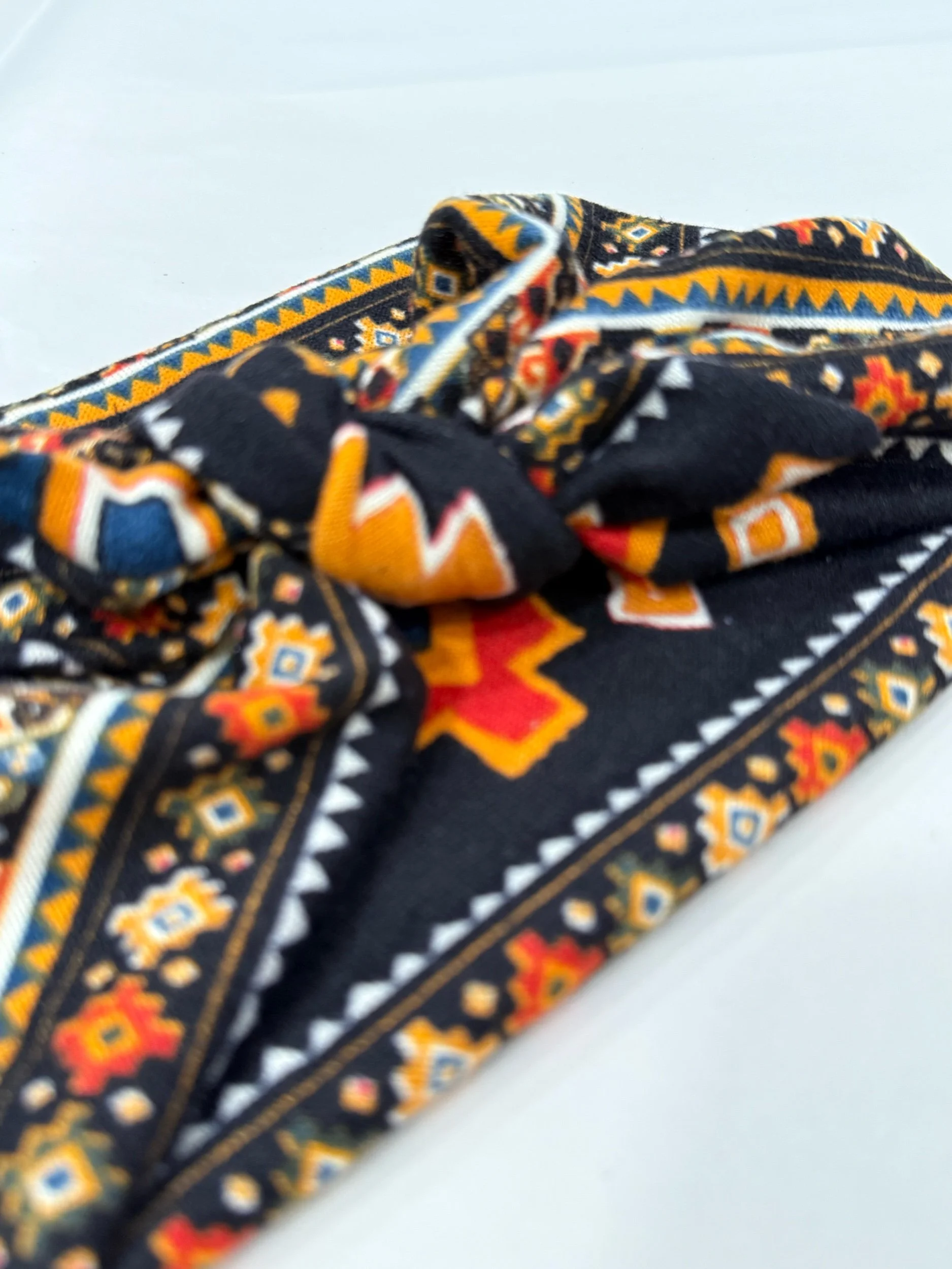 Adjustable southwest knitted fabric headband with colorful printed design, handmade by Seams by Sarah