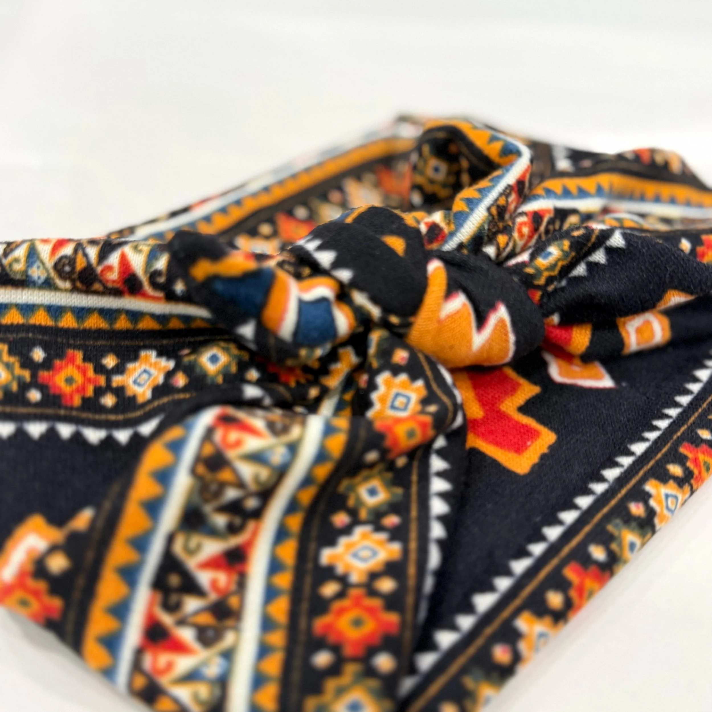 Adjustable southwest knitted fabric headband with colorful printed design, handmade by Seams by Sarah