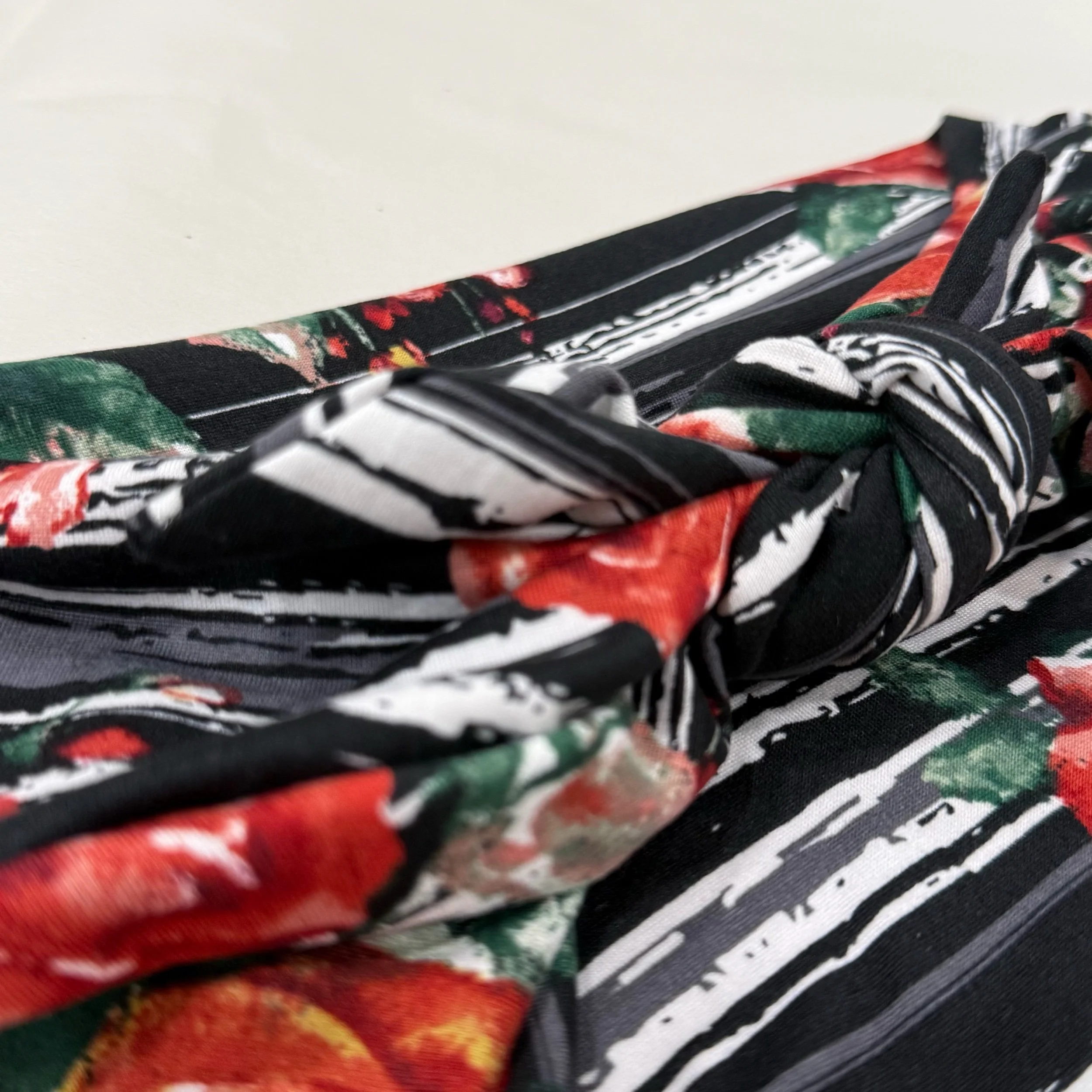 A headband that is Adjustable. It is sewn with  Animal print stretch fabric. To complete the headband you can tie in a square knot. Seams by Sarah