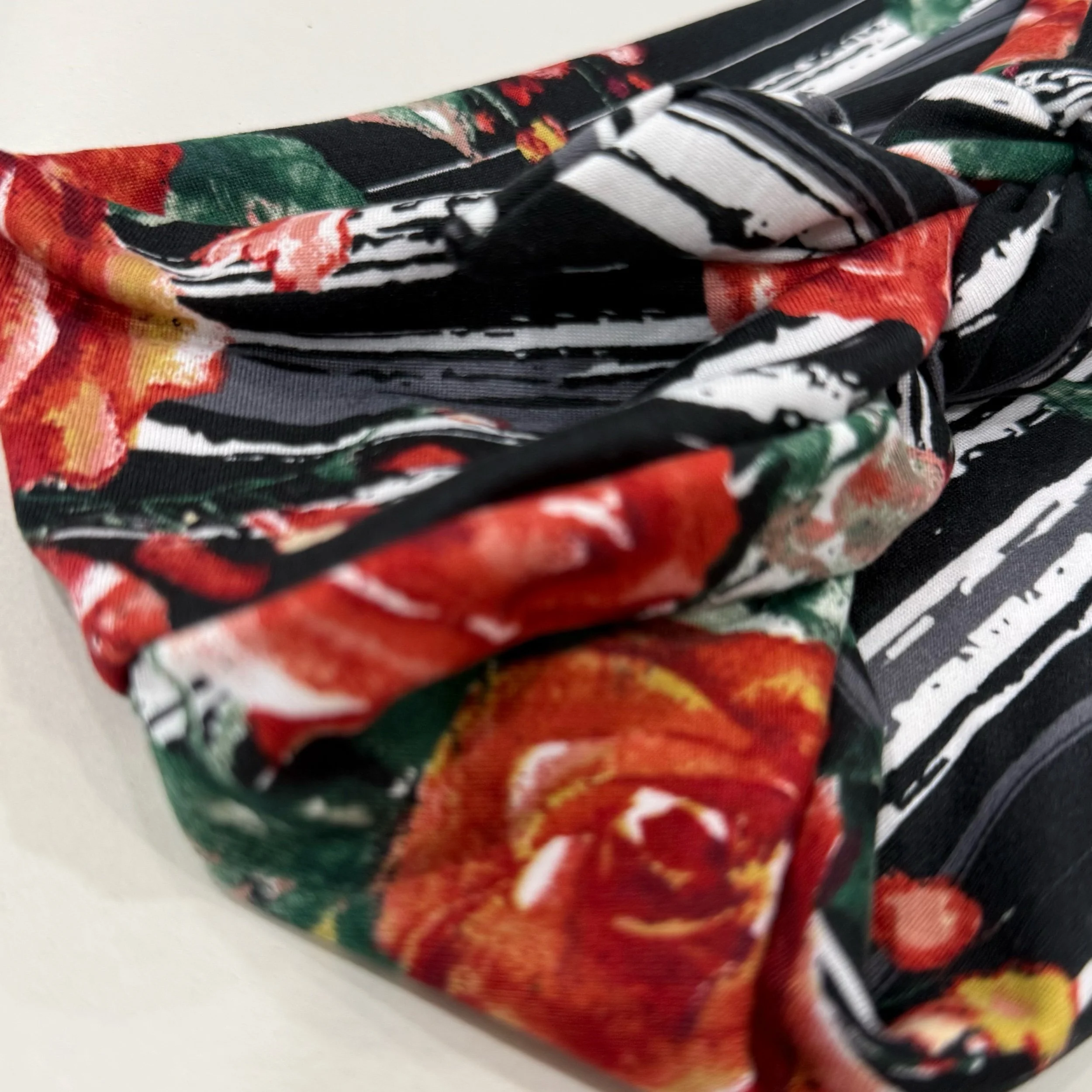 A headband that is Adjustable. It is sewn with  Animal print stretch fabric. To complete the headband you can tie in a square knot. Seams by Sarah