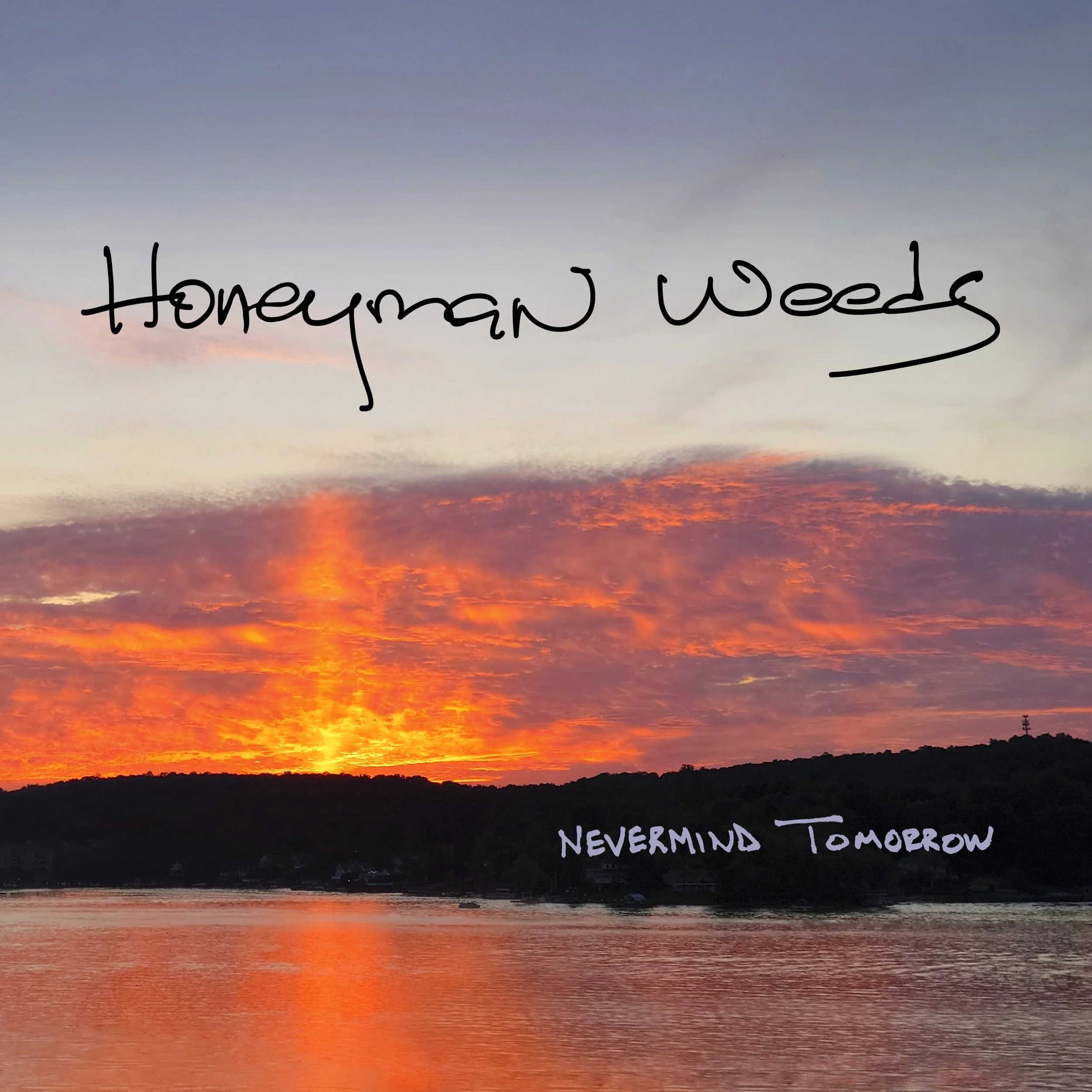 A sunset over a body of water with classes of orange, pink, and purple clouds, and handwritten text that says 'Honeymoon Weds' and 'Nevermind Tomorrow'.