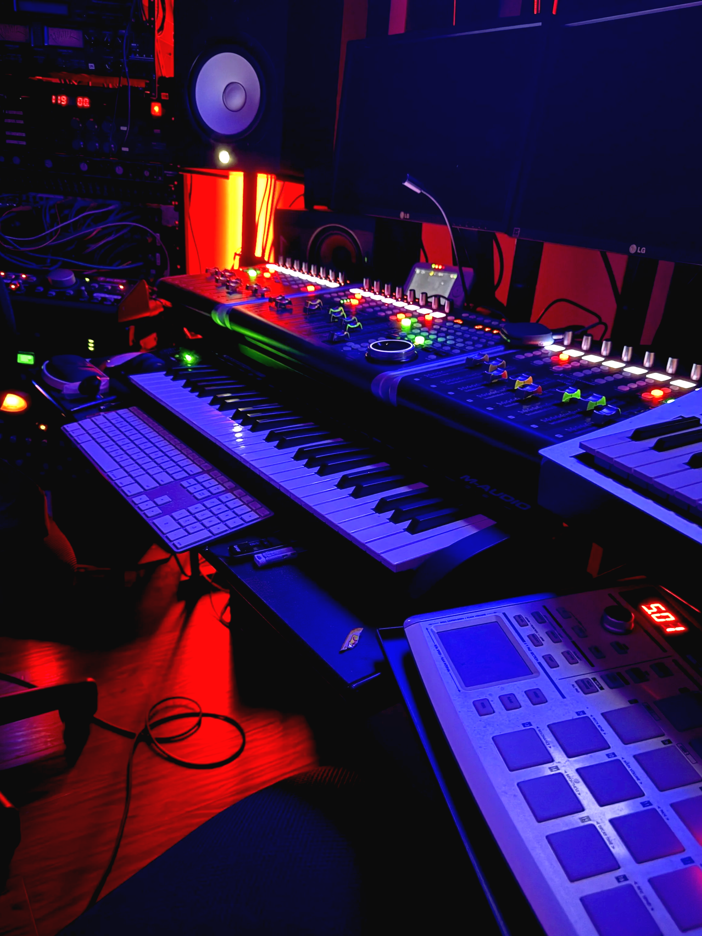 Music Studio Control Room showing mood lights and illuminated console as well as other recording equipment.